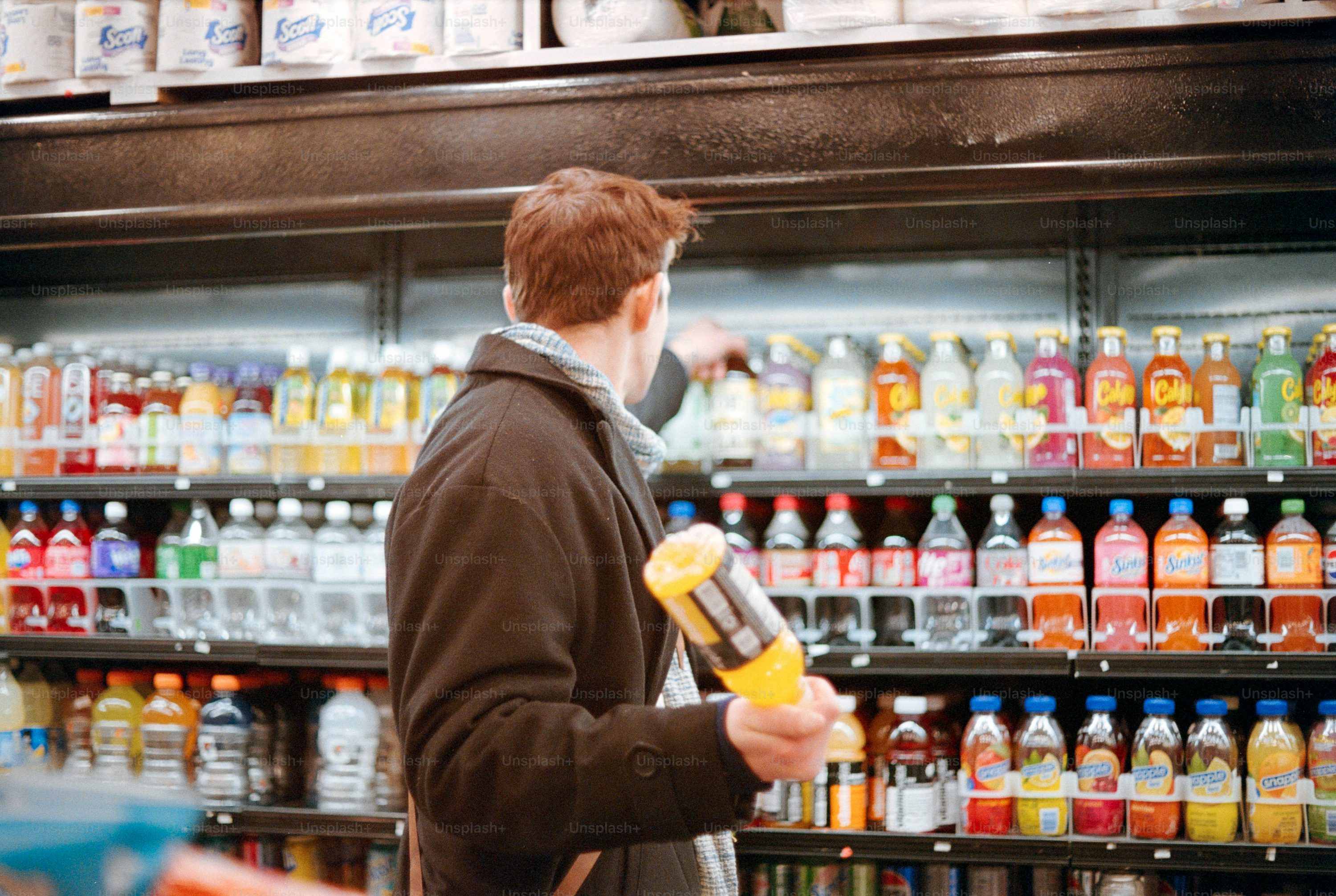 Man shopping for drinks in a supermarket.