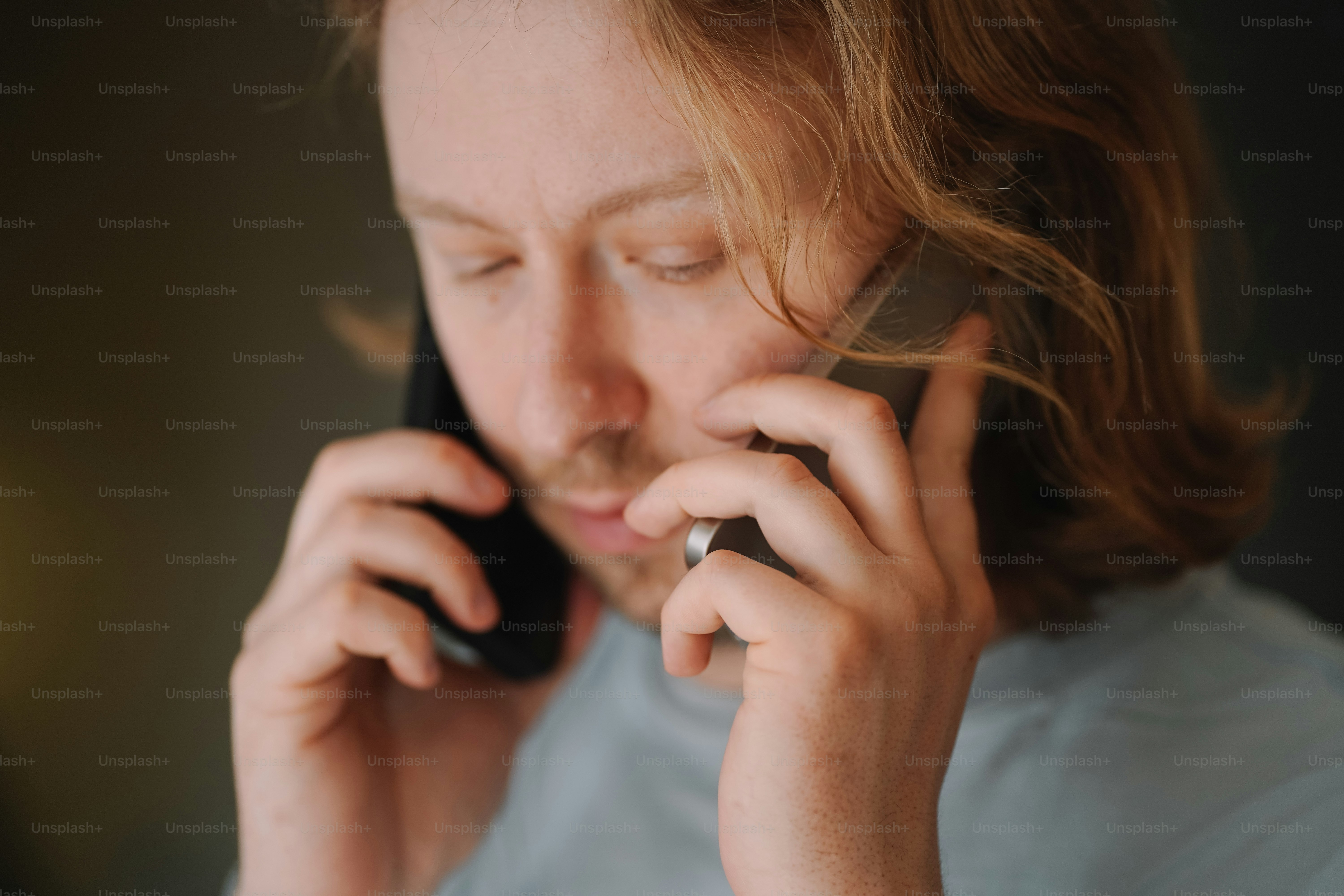 Man talks on two phones simultaneously - Photo on Unsplash+