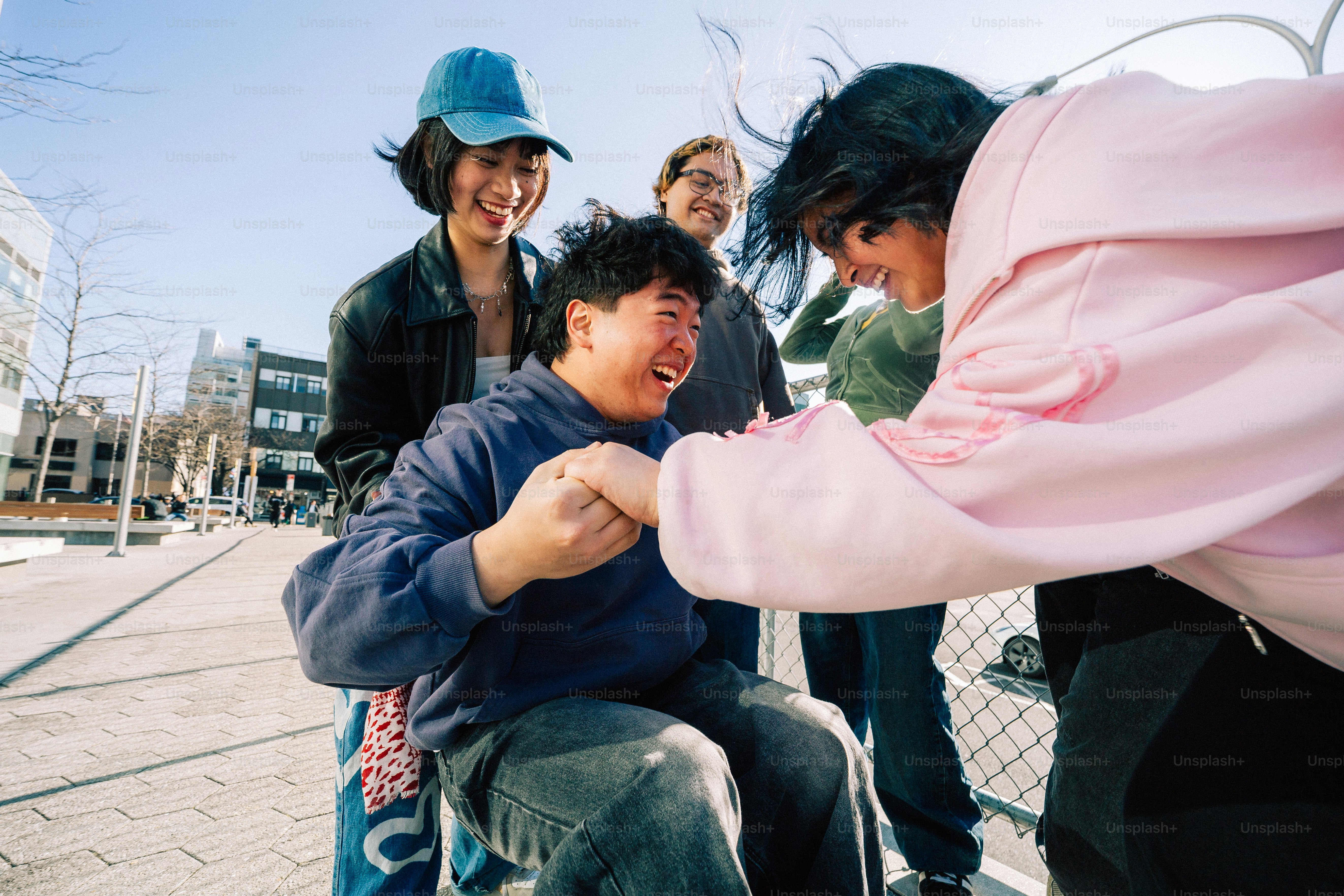 Friends laugh and share happy moments together outside.