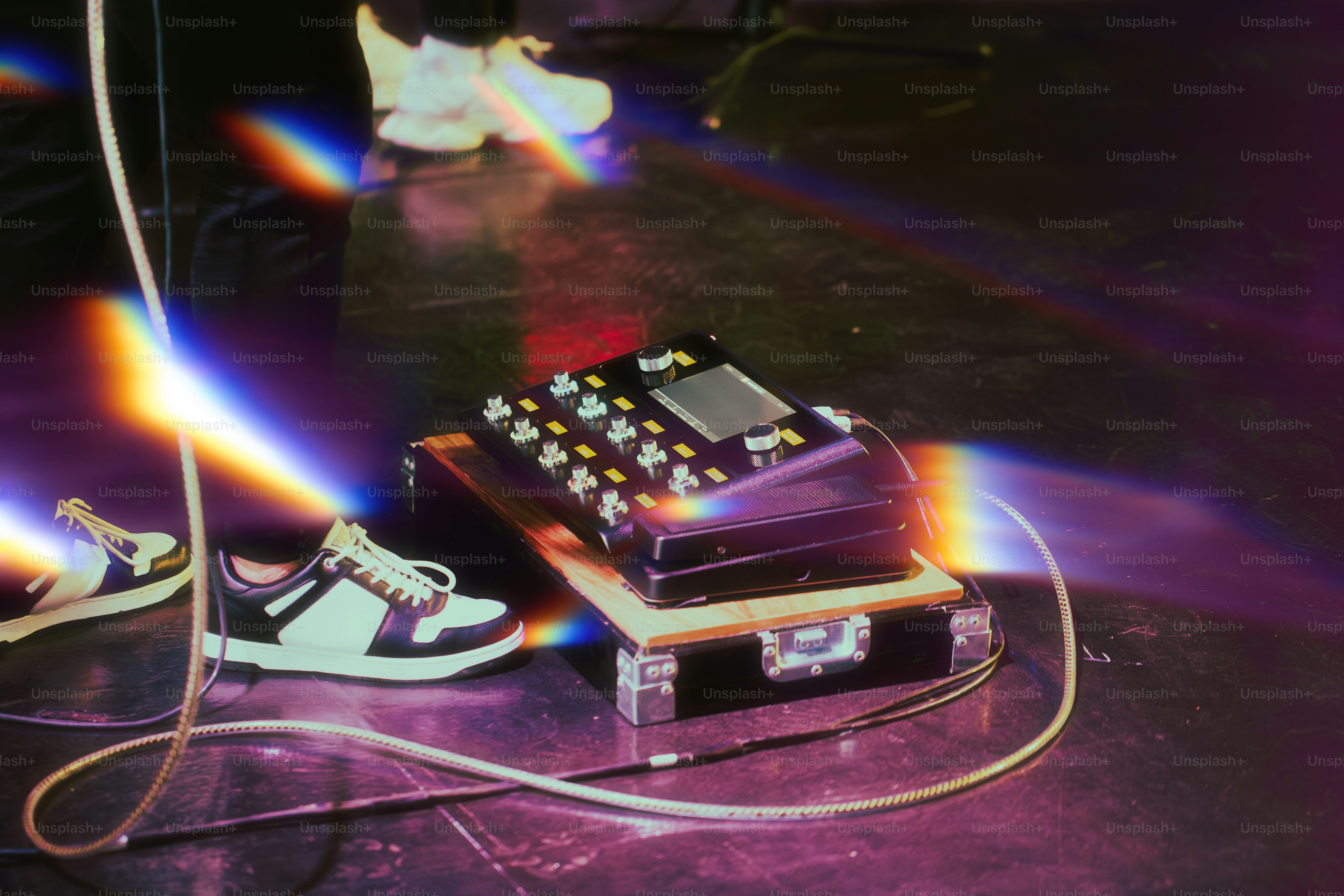 A music device sits near shoes, onstage.