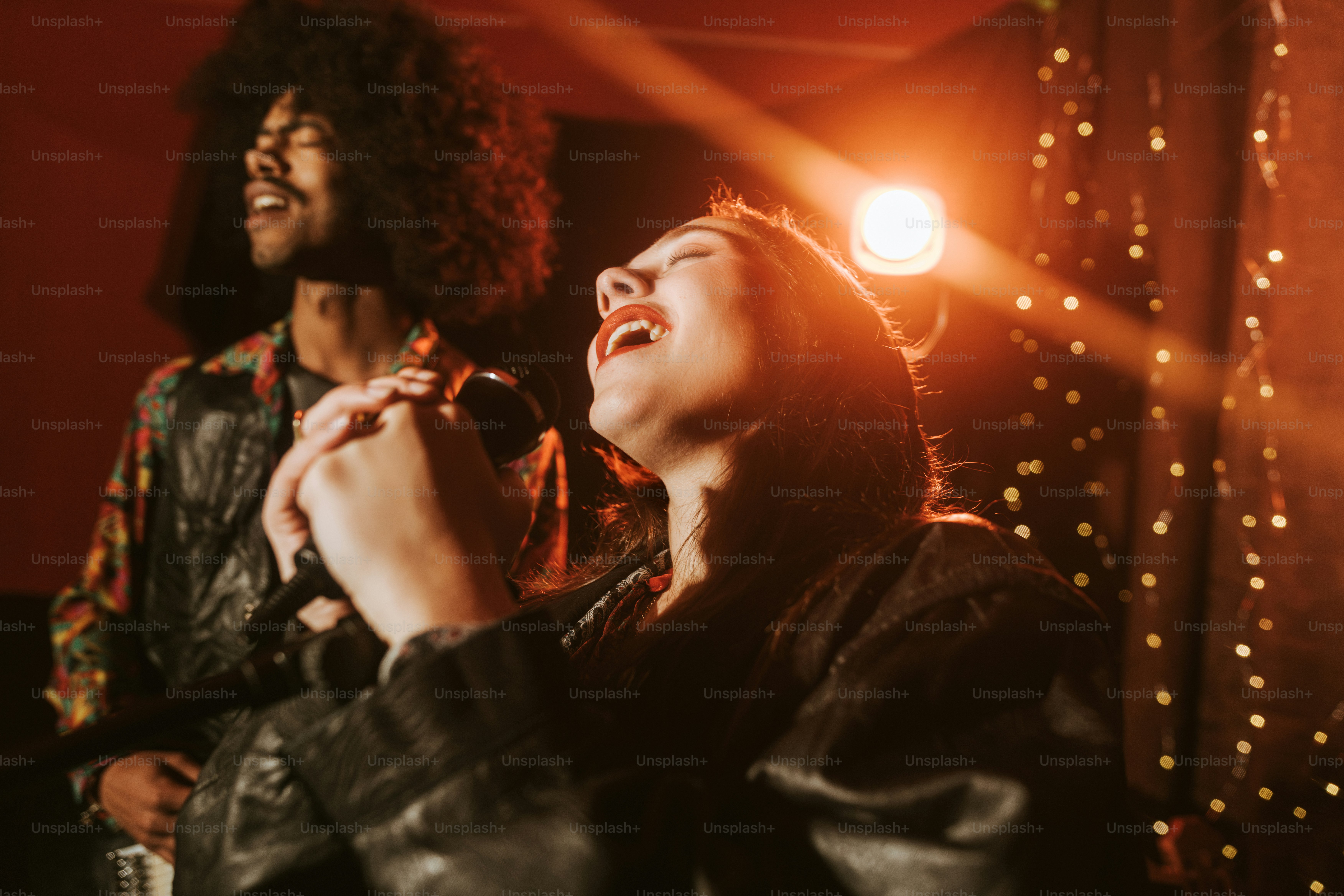 A singer performs on stage with guitarist. photo – Music Image on Unsplash