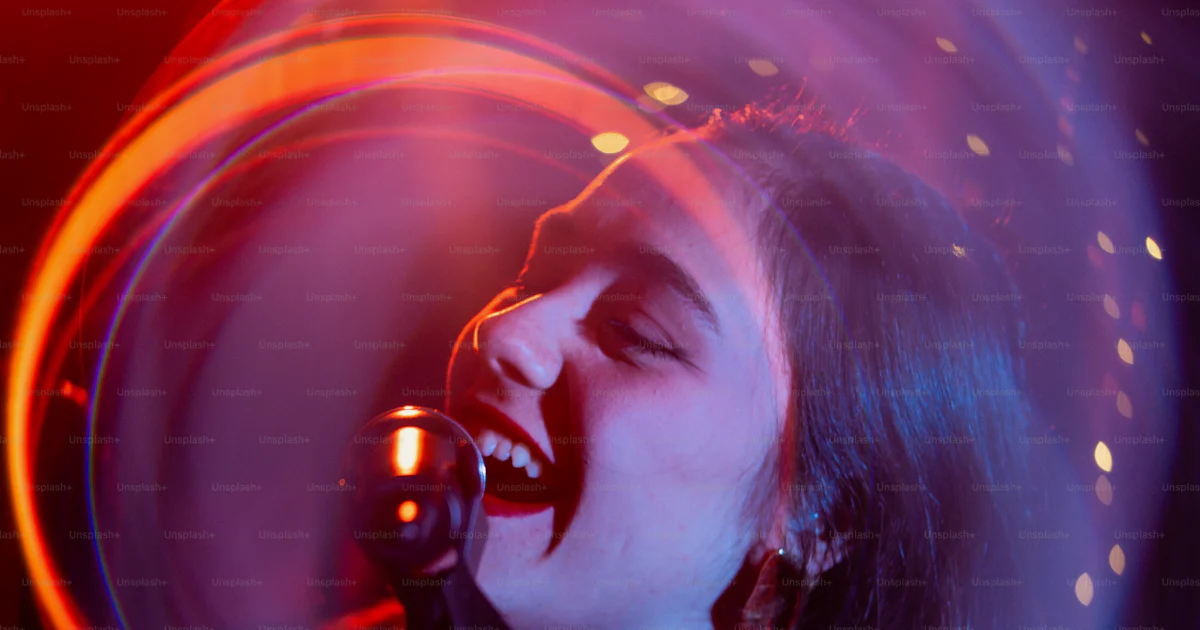 Singer is passionately performing in a colorful light. photo – Music ...