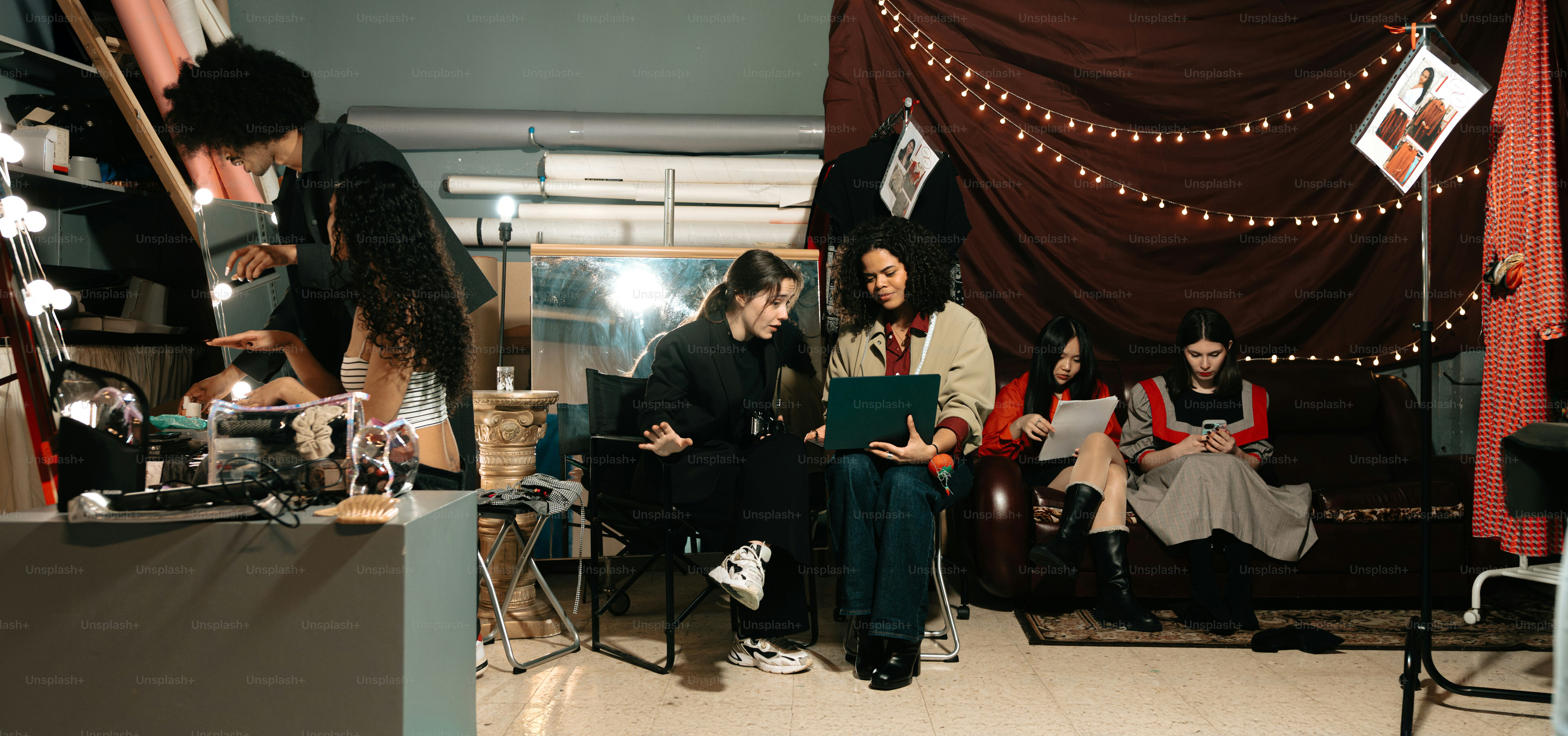 A group of people are gathered in a studio.