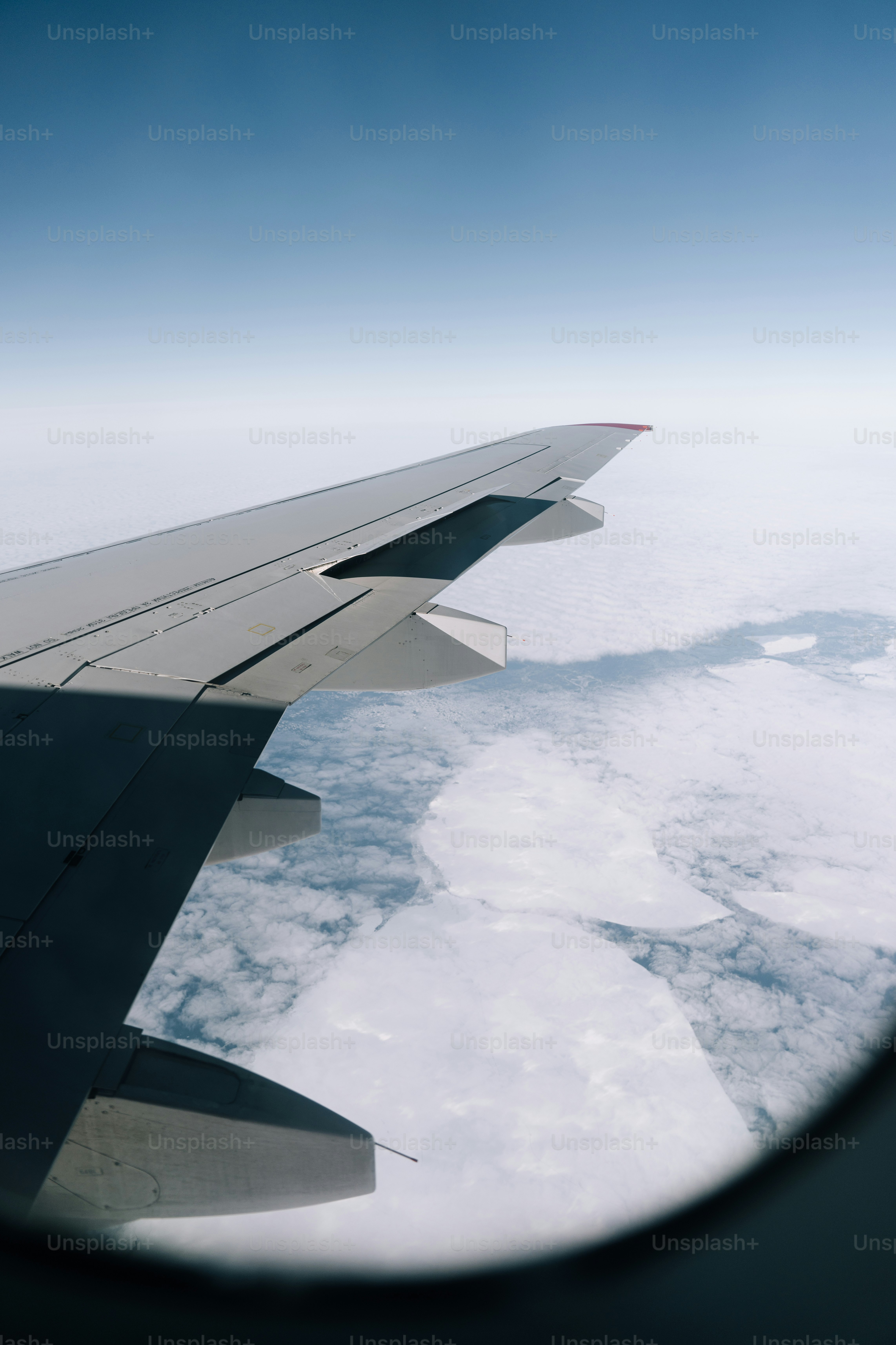 Airplane wing soaring above the clouds.