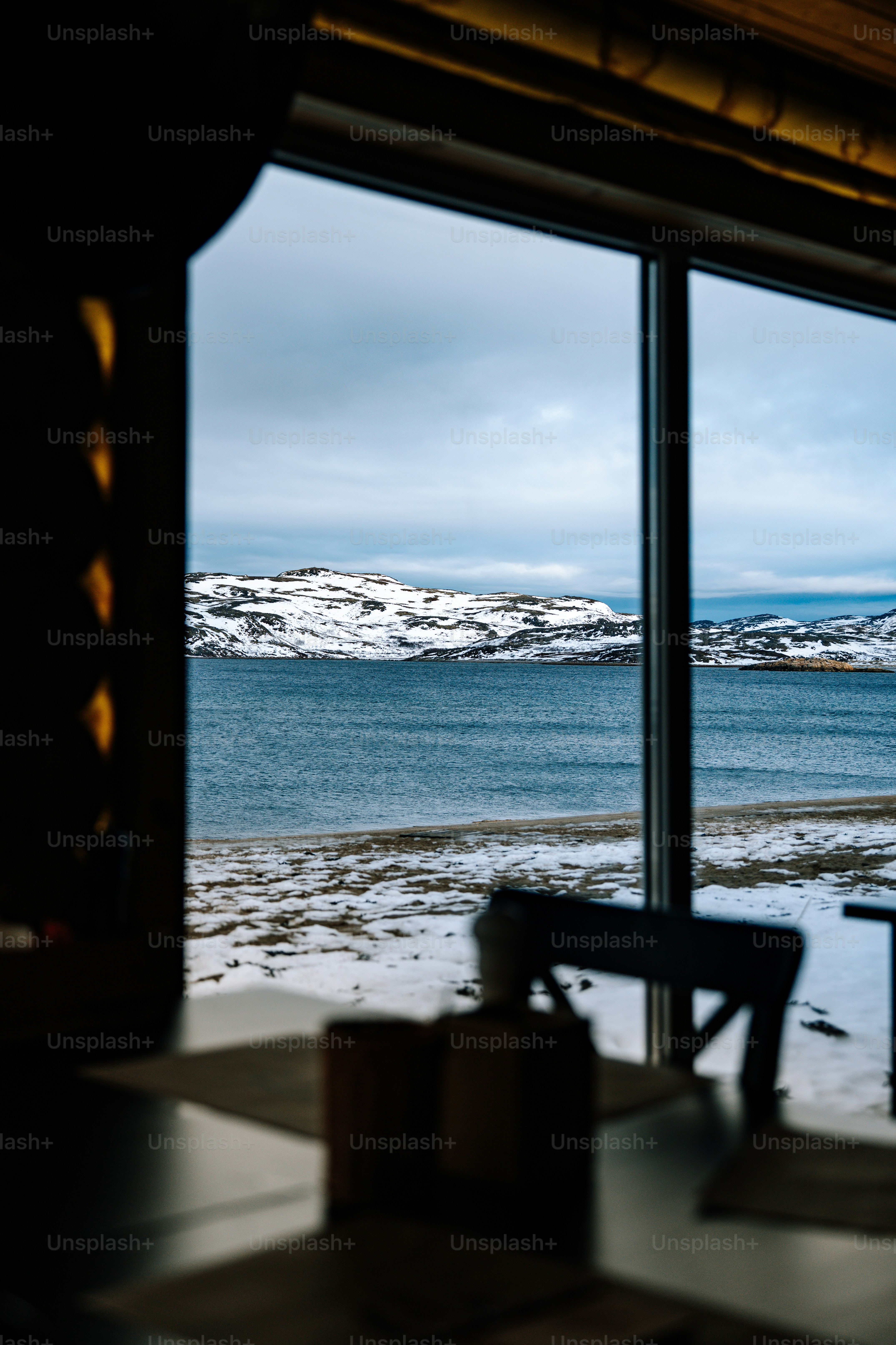 A snowy landscape seen through a window.