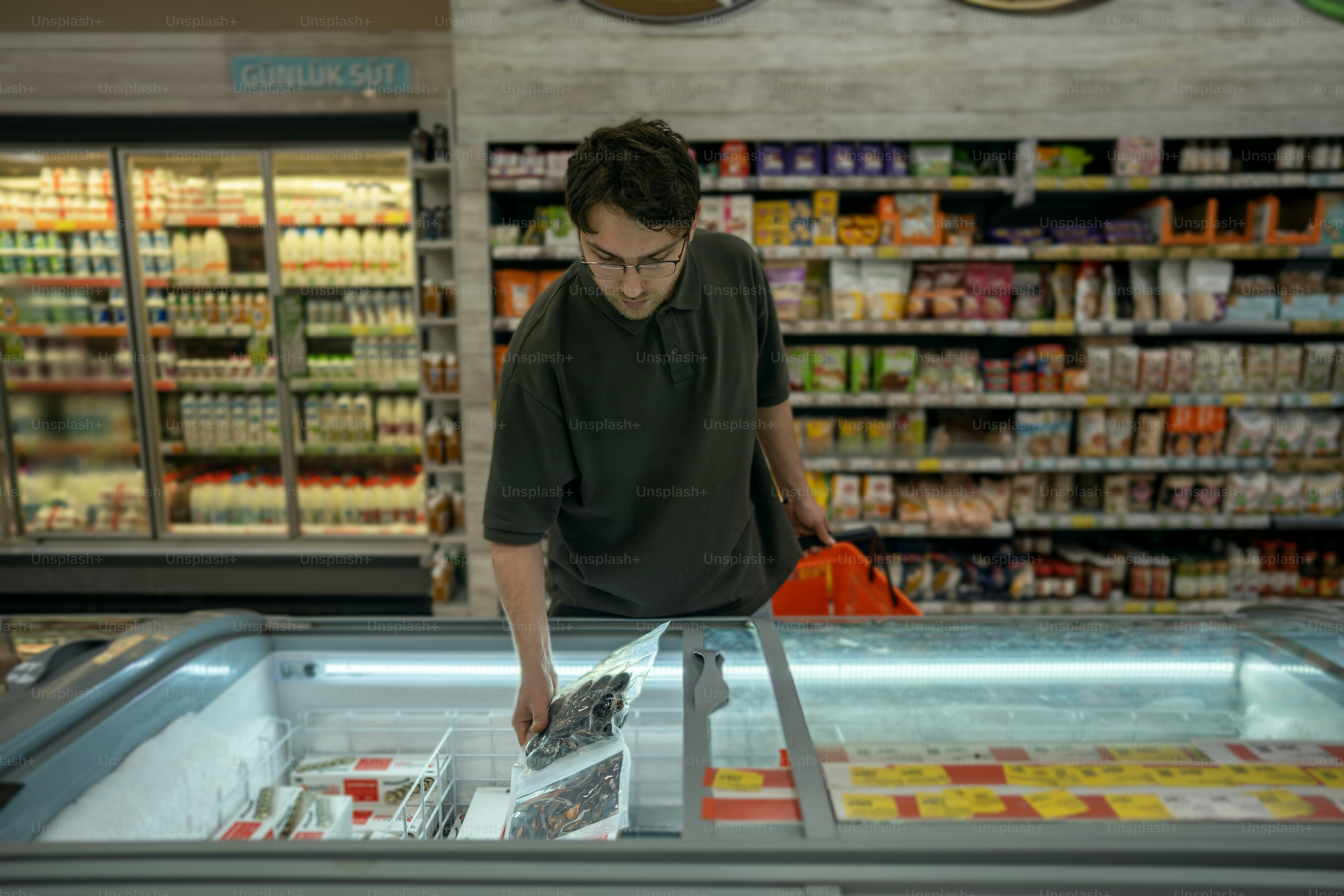 A man shops for groceries in a supermarket.