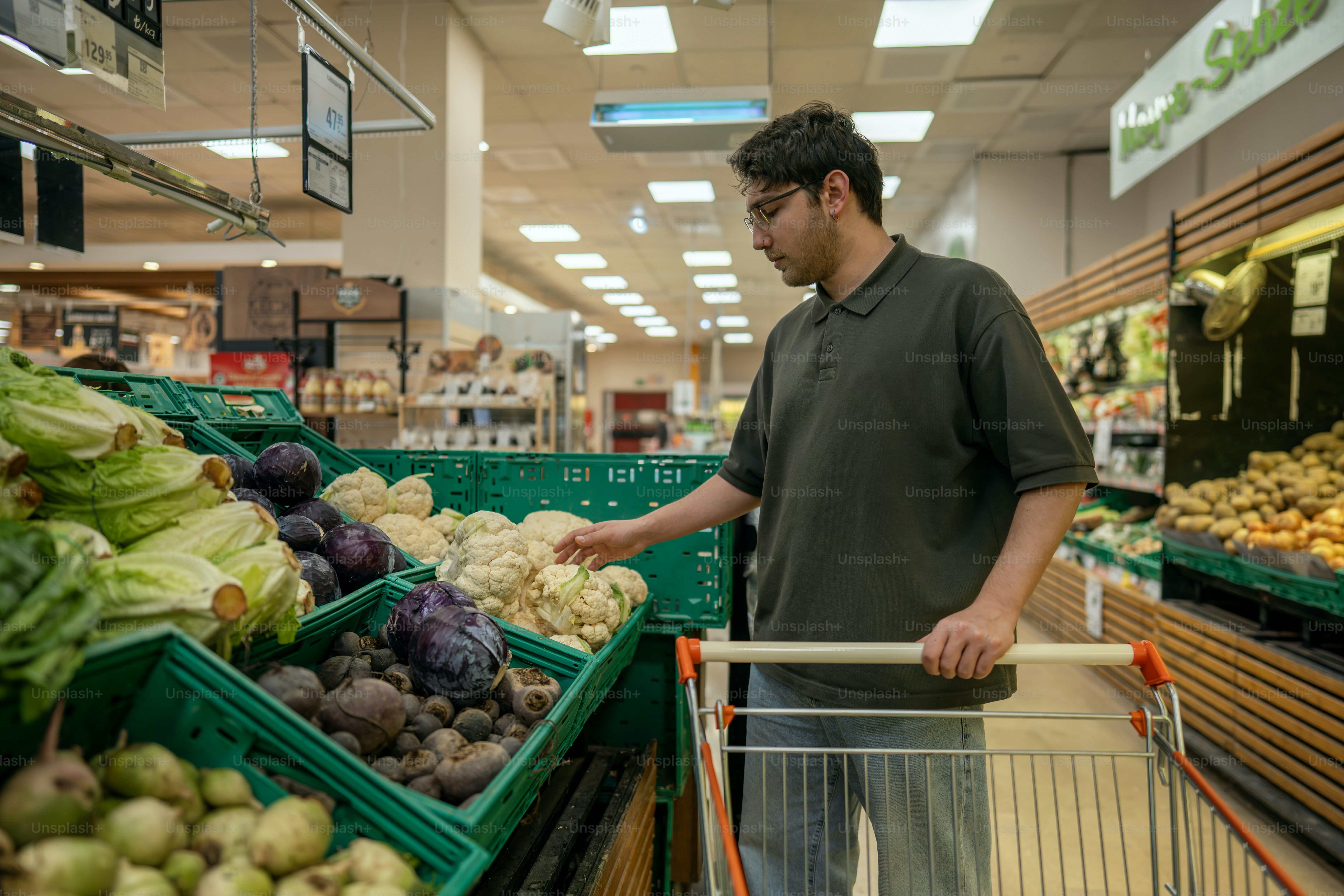 Man shops for fresh vegetables in the grocery store.