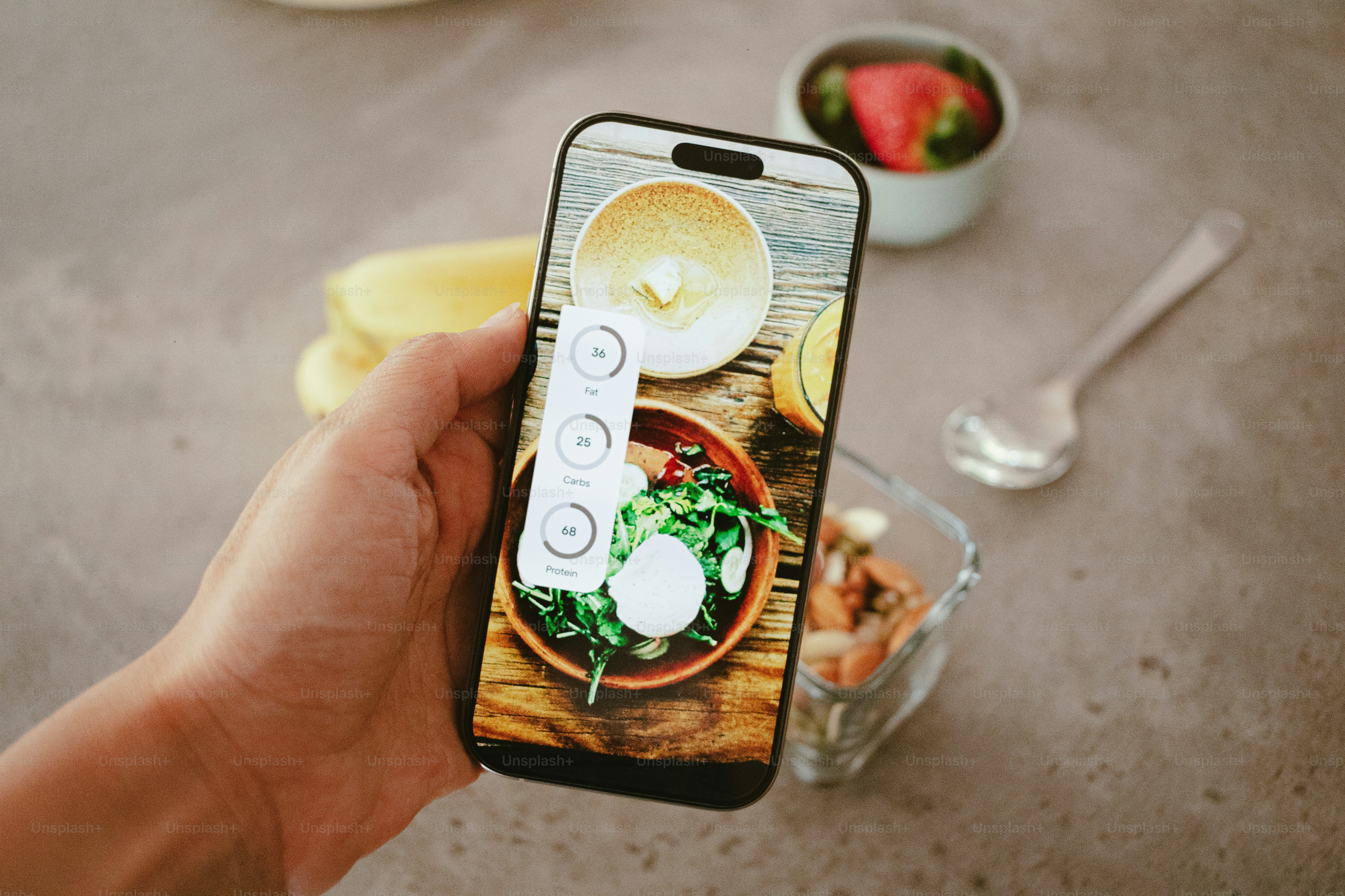 A phone takes a picture of a salad.