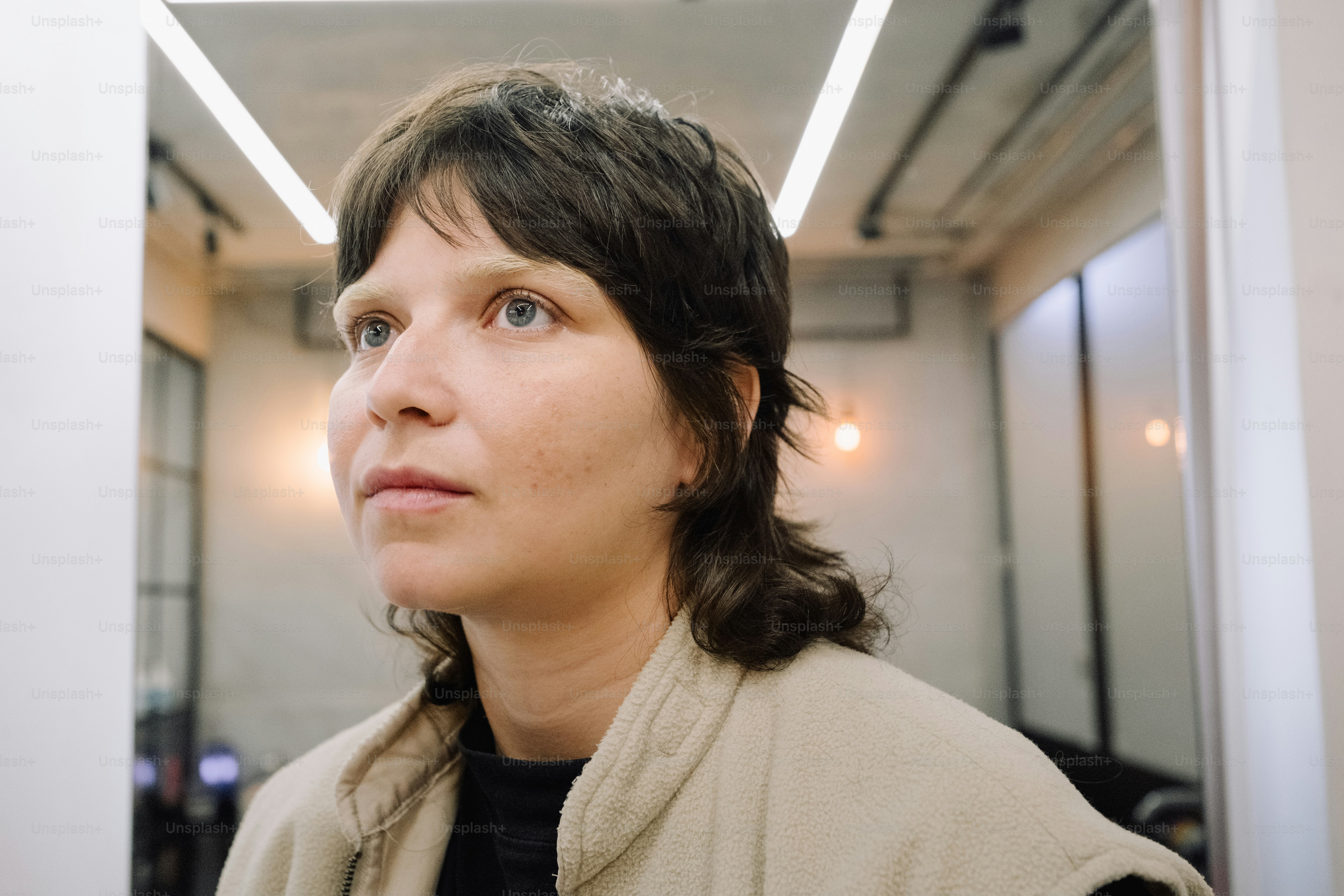 A woman with a thoughtful look inside a building. photo – Portrait ...
