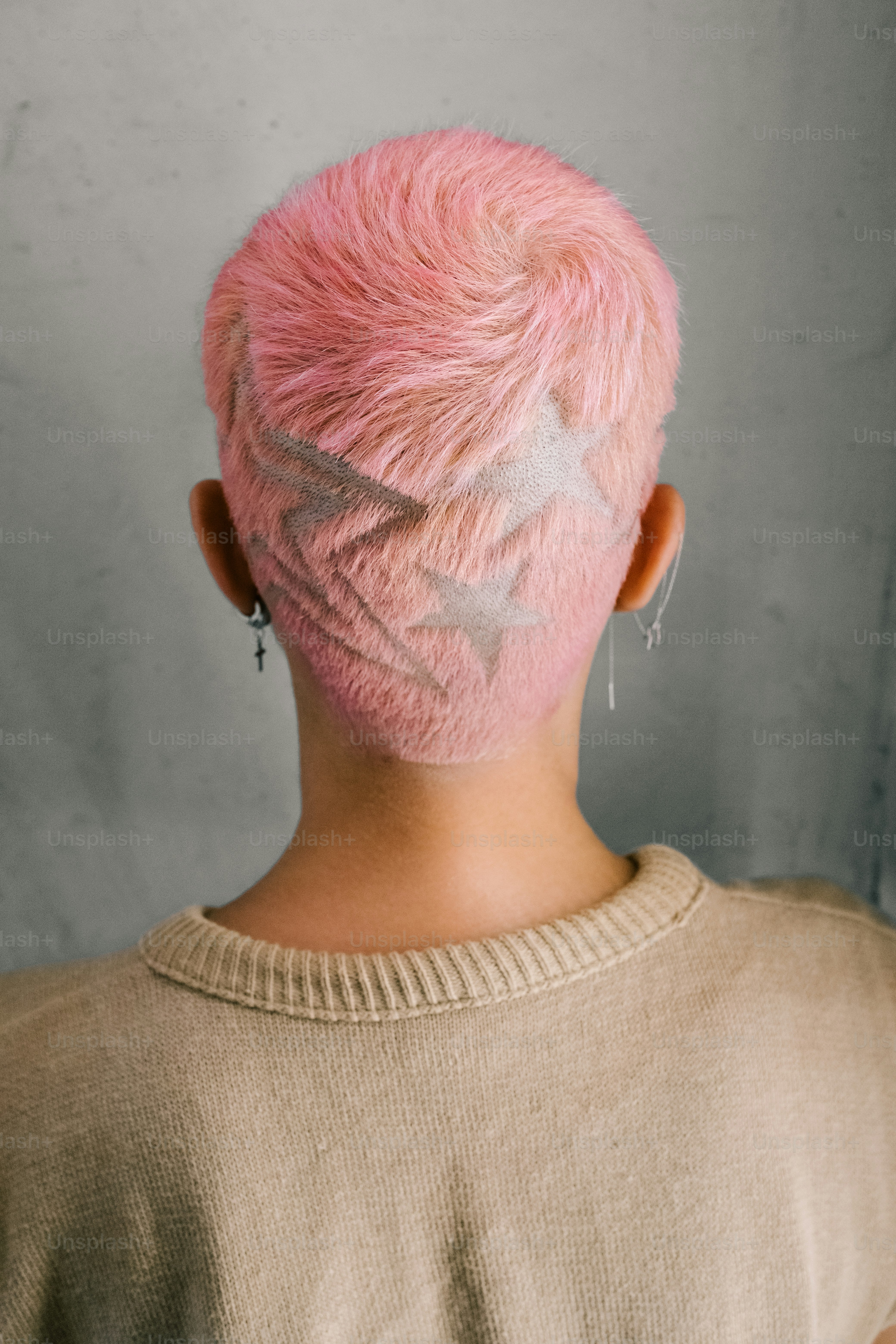 Pink hair with star-shaped shaved design.