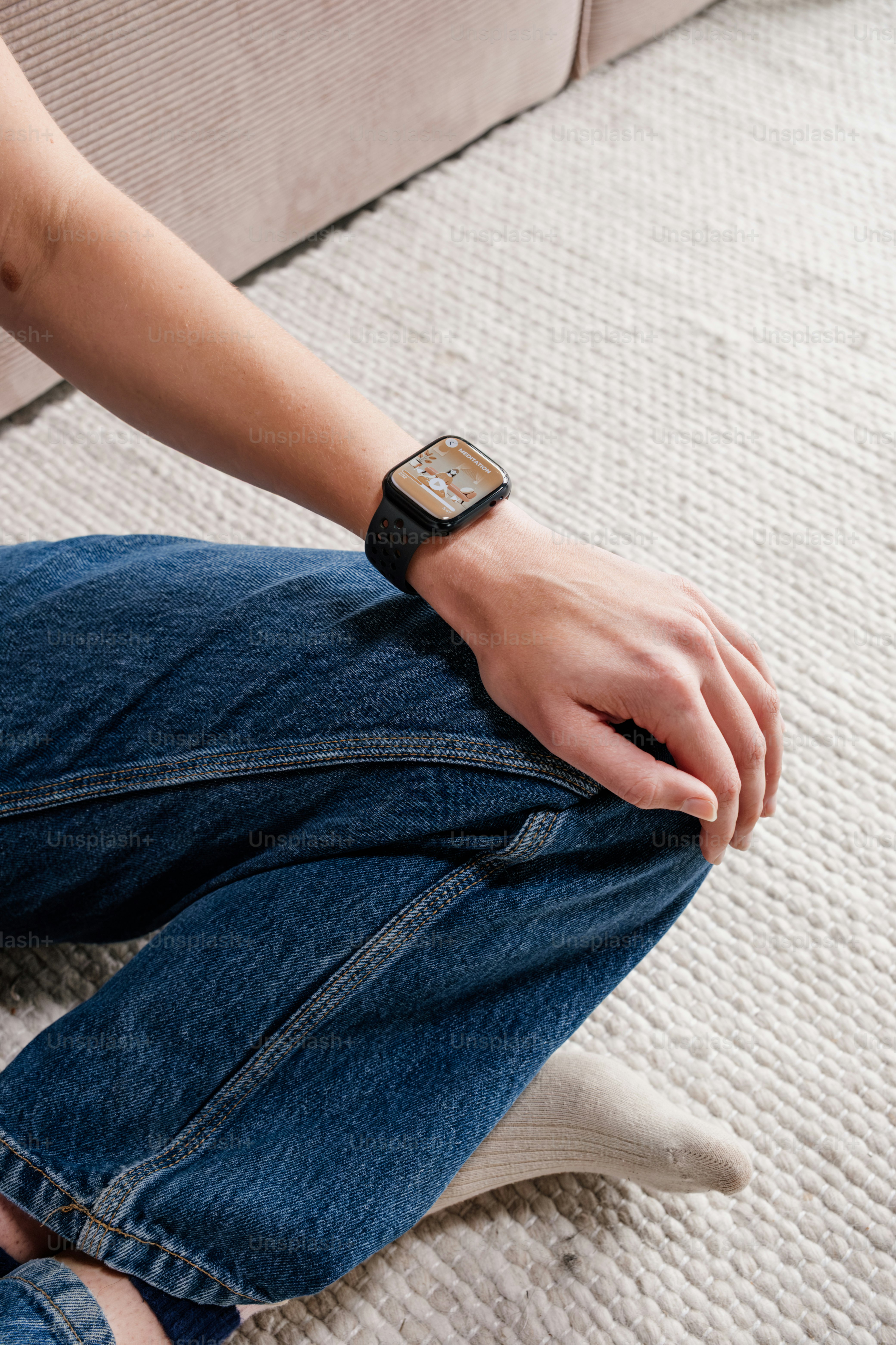 A person wears a watch while sitting.