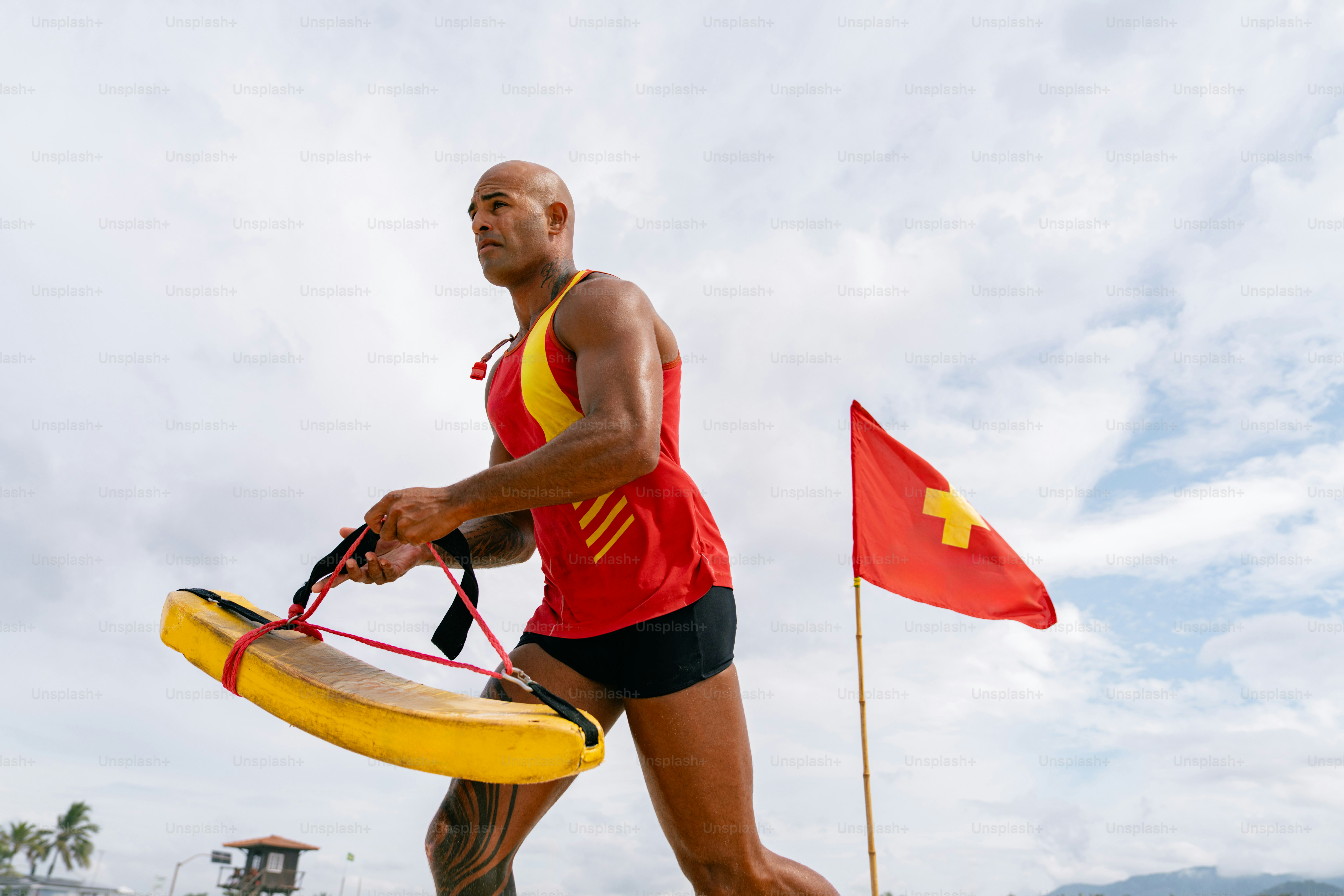 A lifeguard runs towards the water.