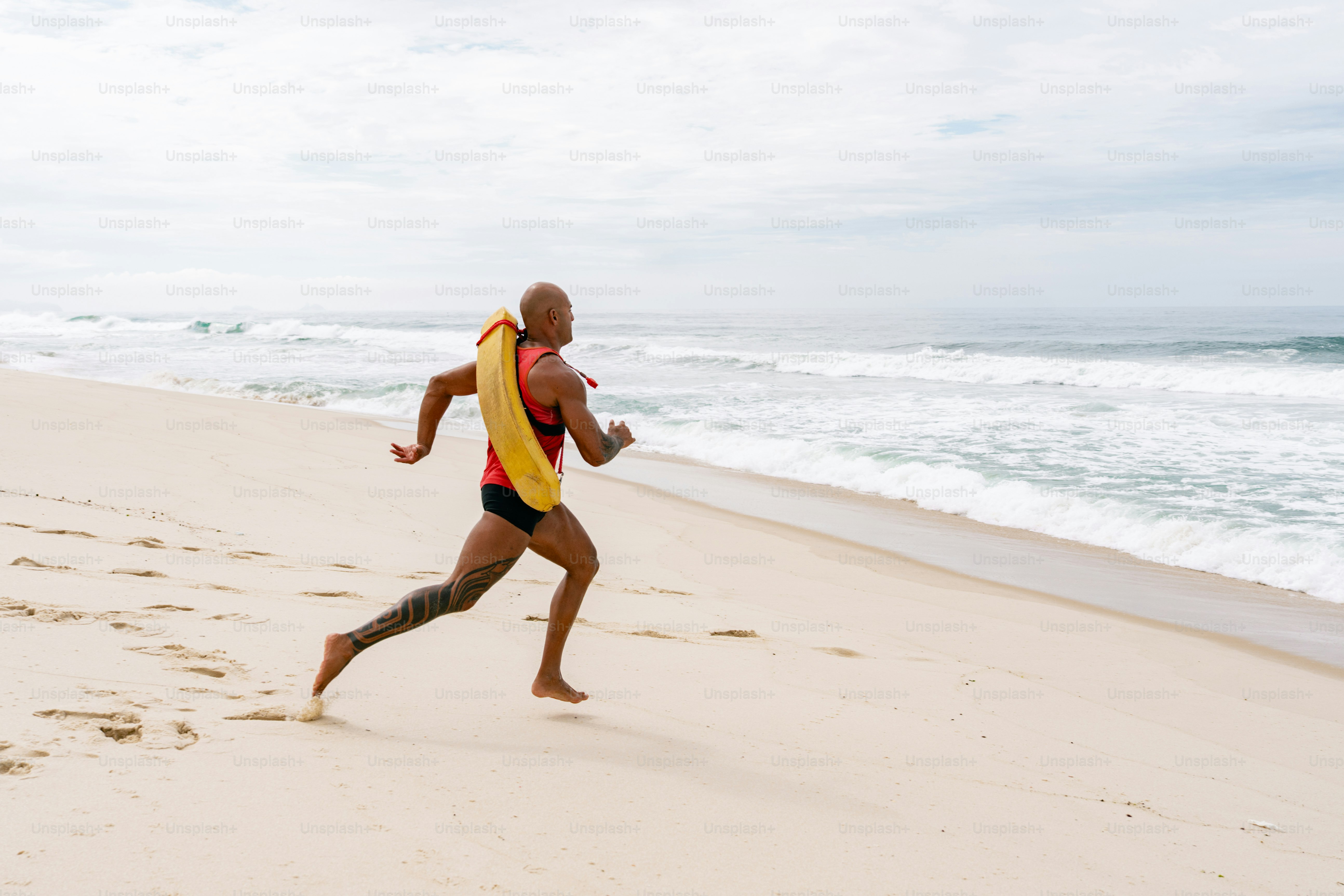 Lifeguard runs toward the ocean for a rescue.