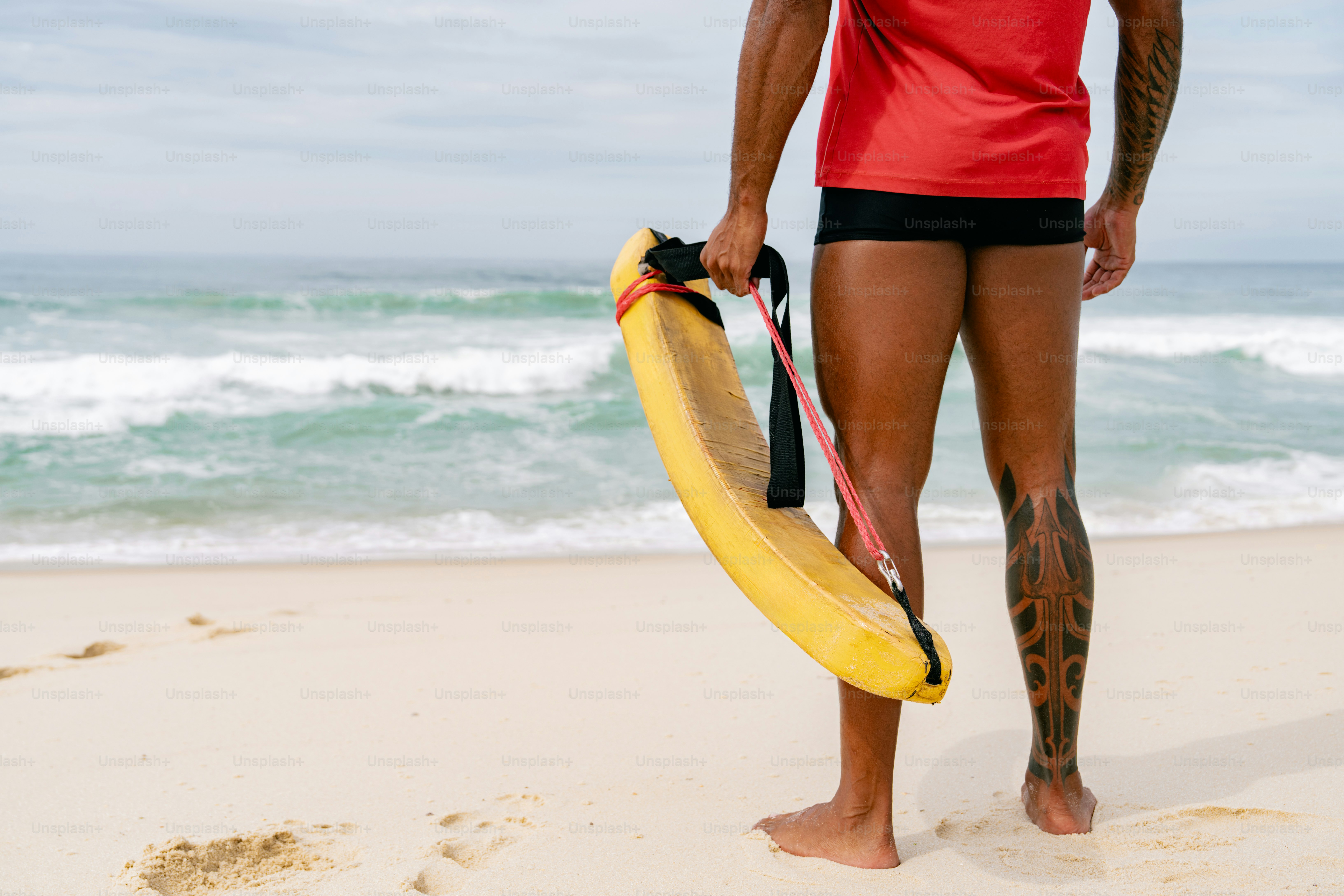 Lifeguard stands on the beach with rescue buoy.