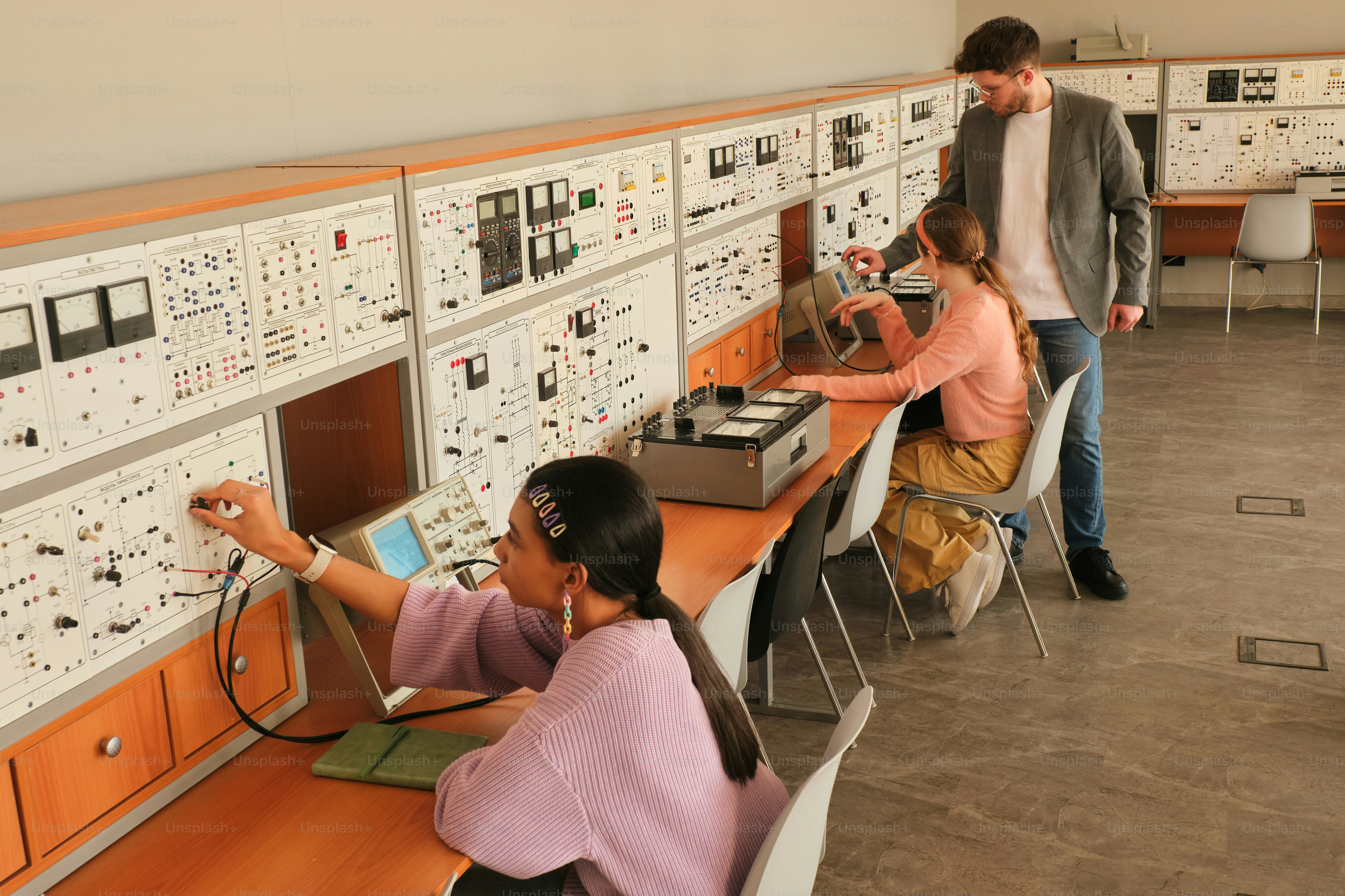 Students work with equipment in a lab.