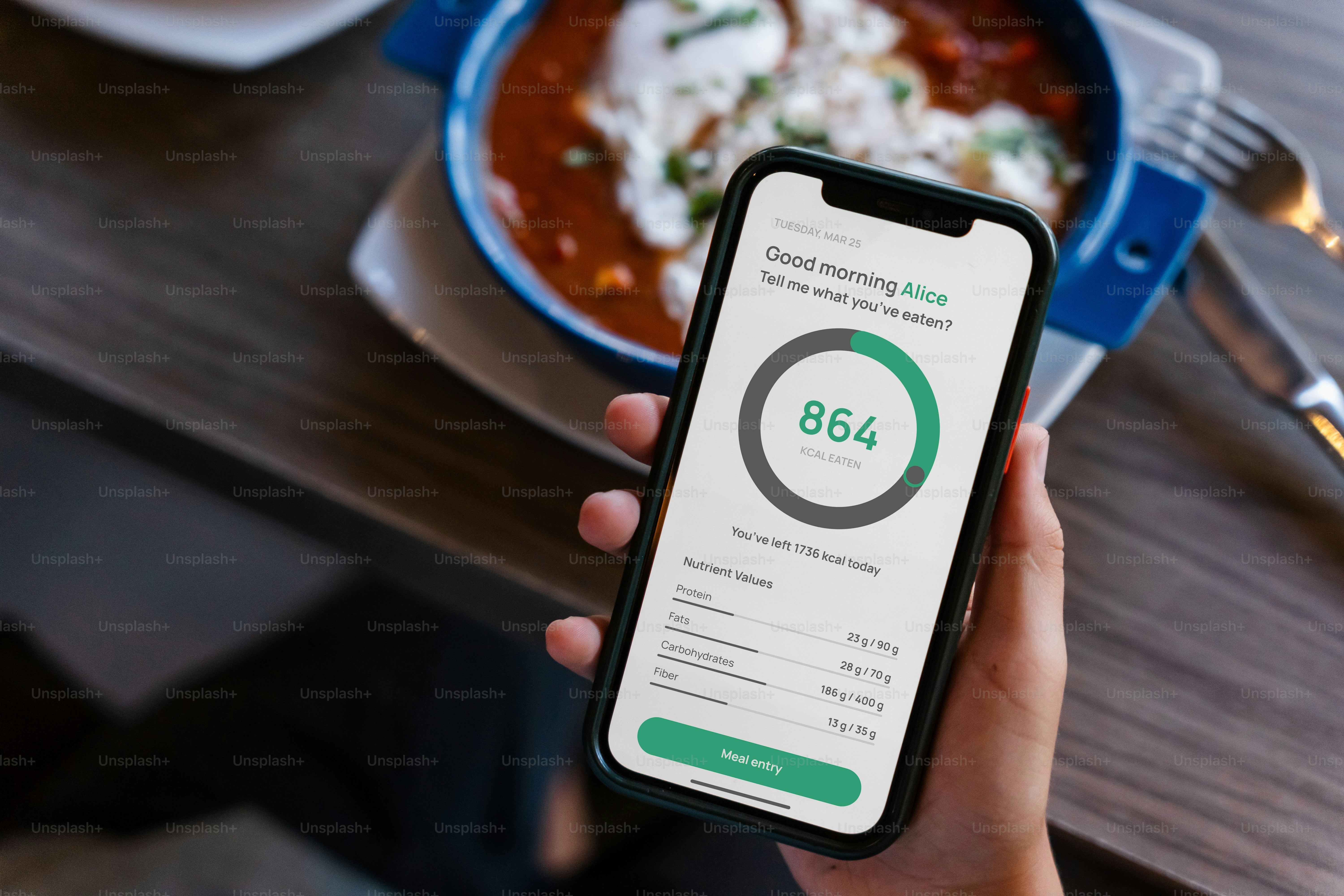 A person uses a food tracking app at breakfast.