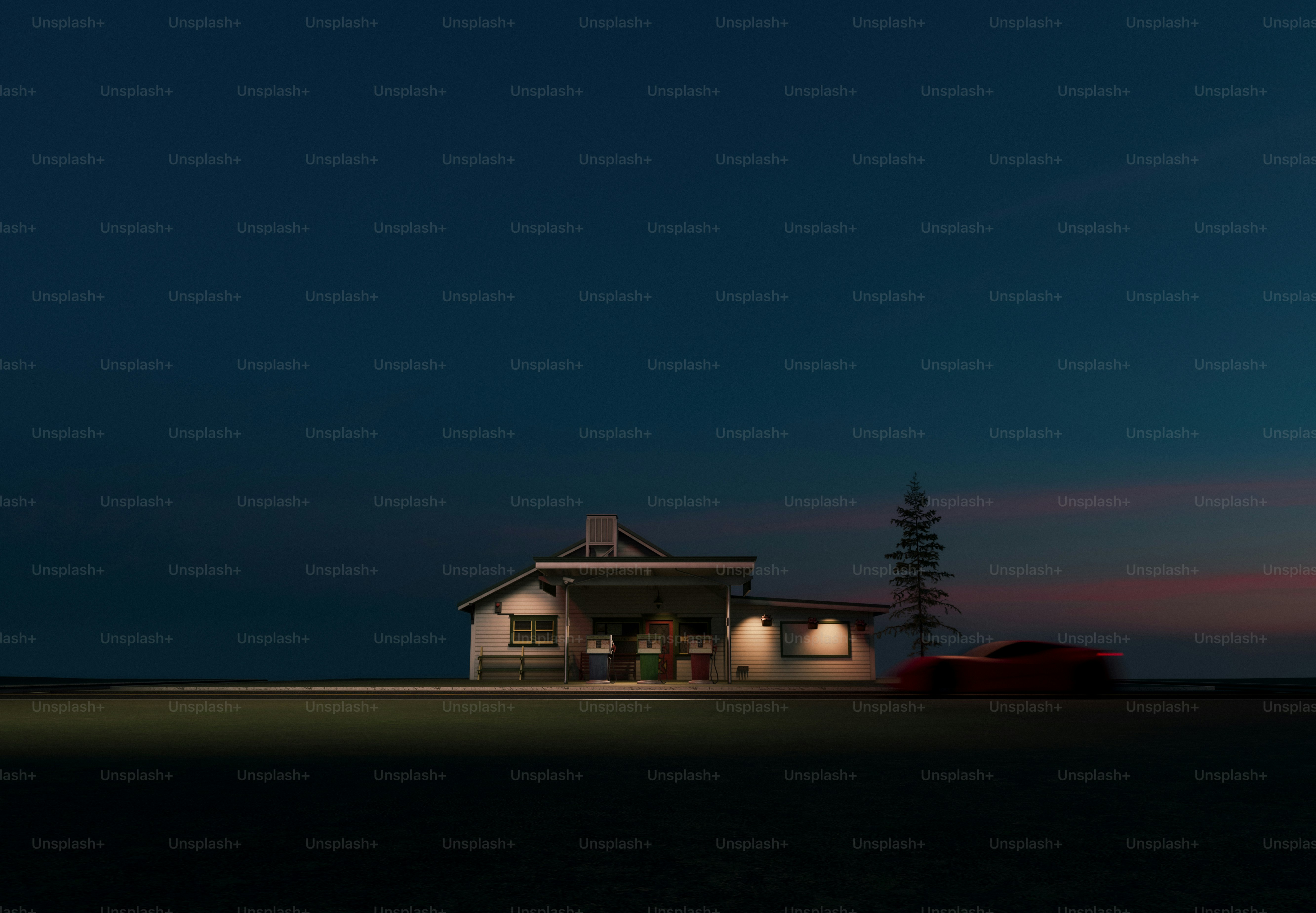 A lit house stands silhouetted against a dark sky.