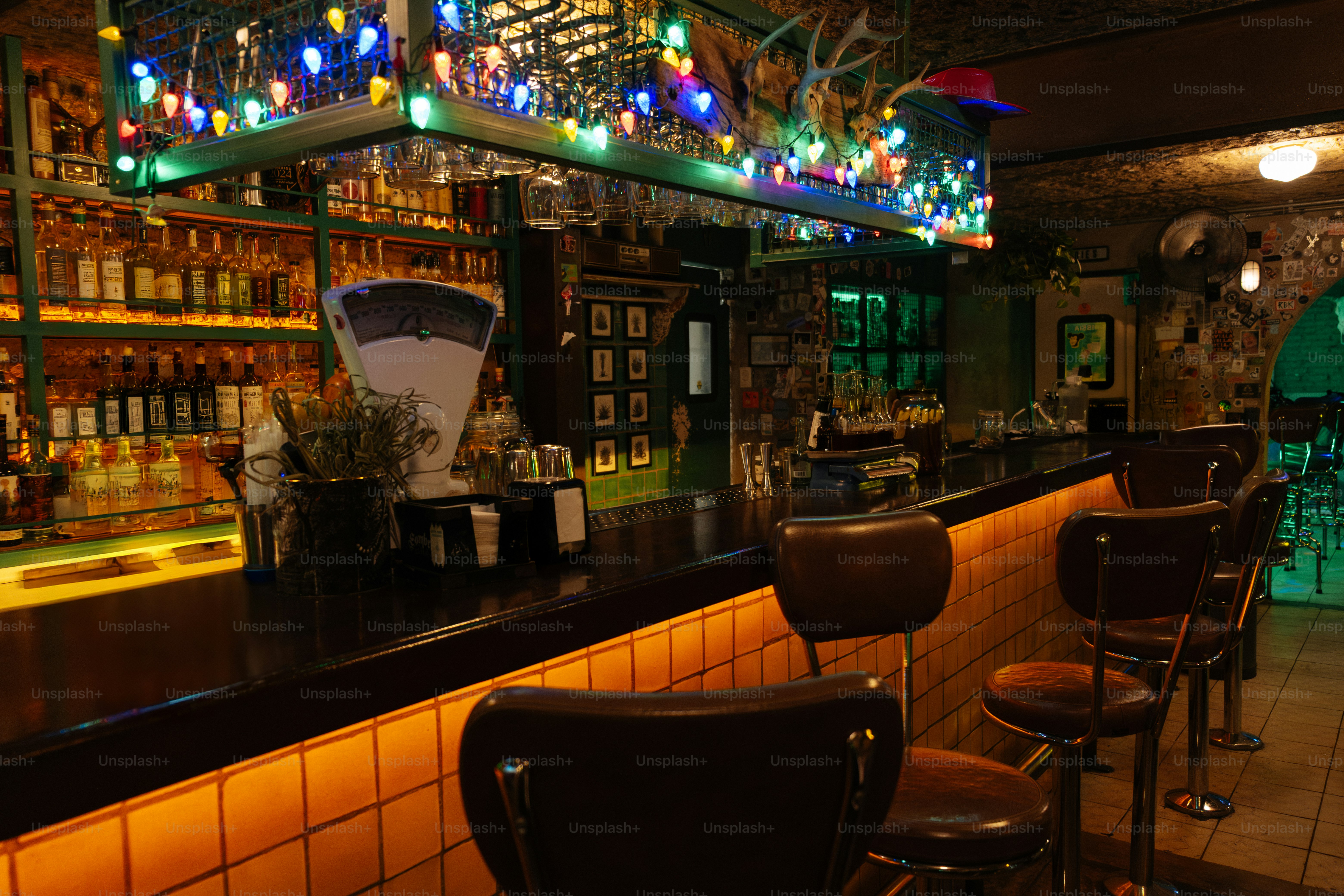 A cozy, vintage bar with colorful lights.