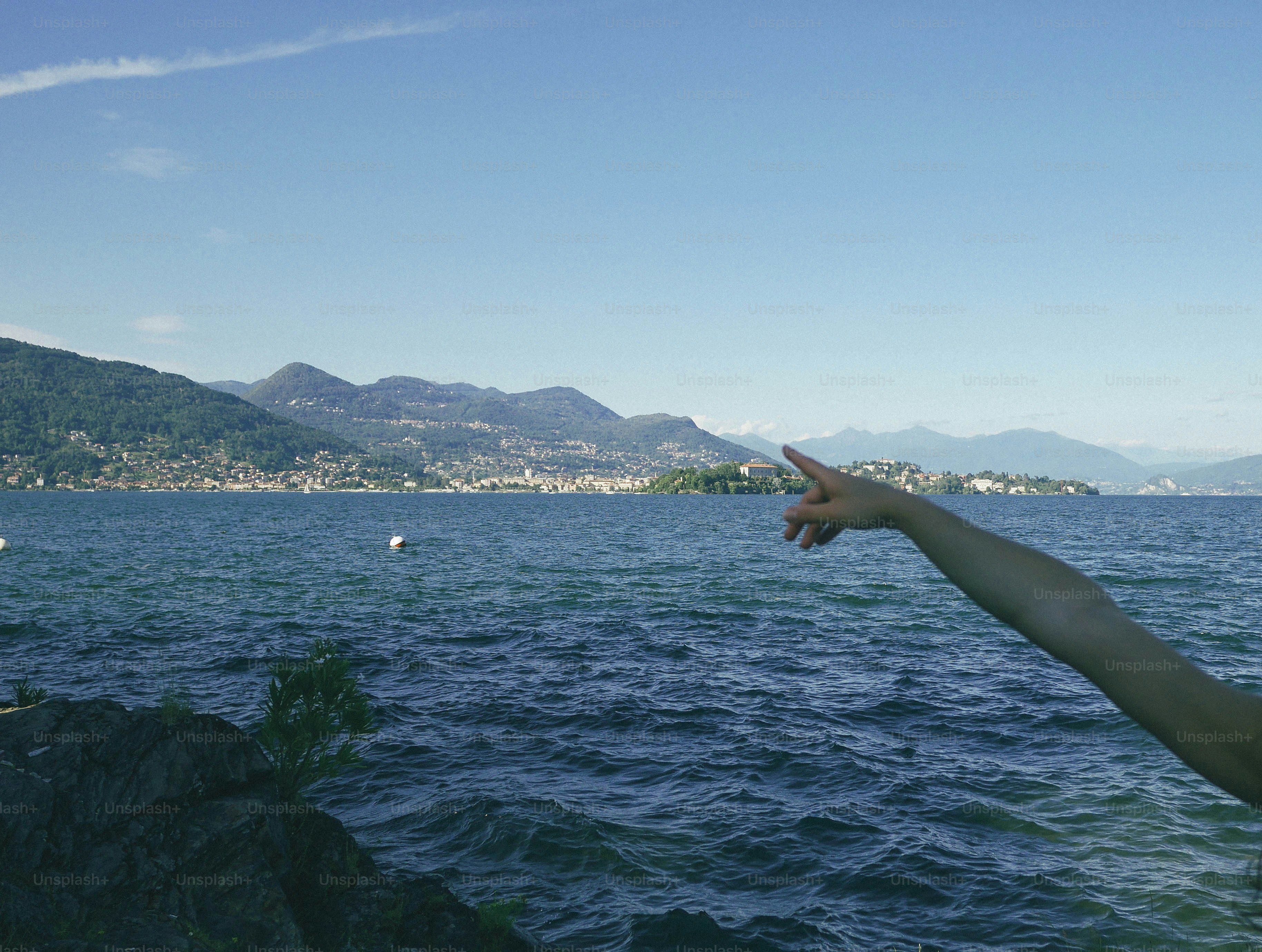 Someone is pointing at a scenic lake view
