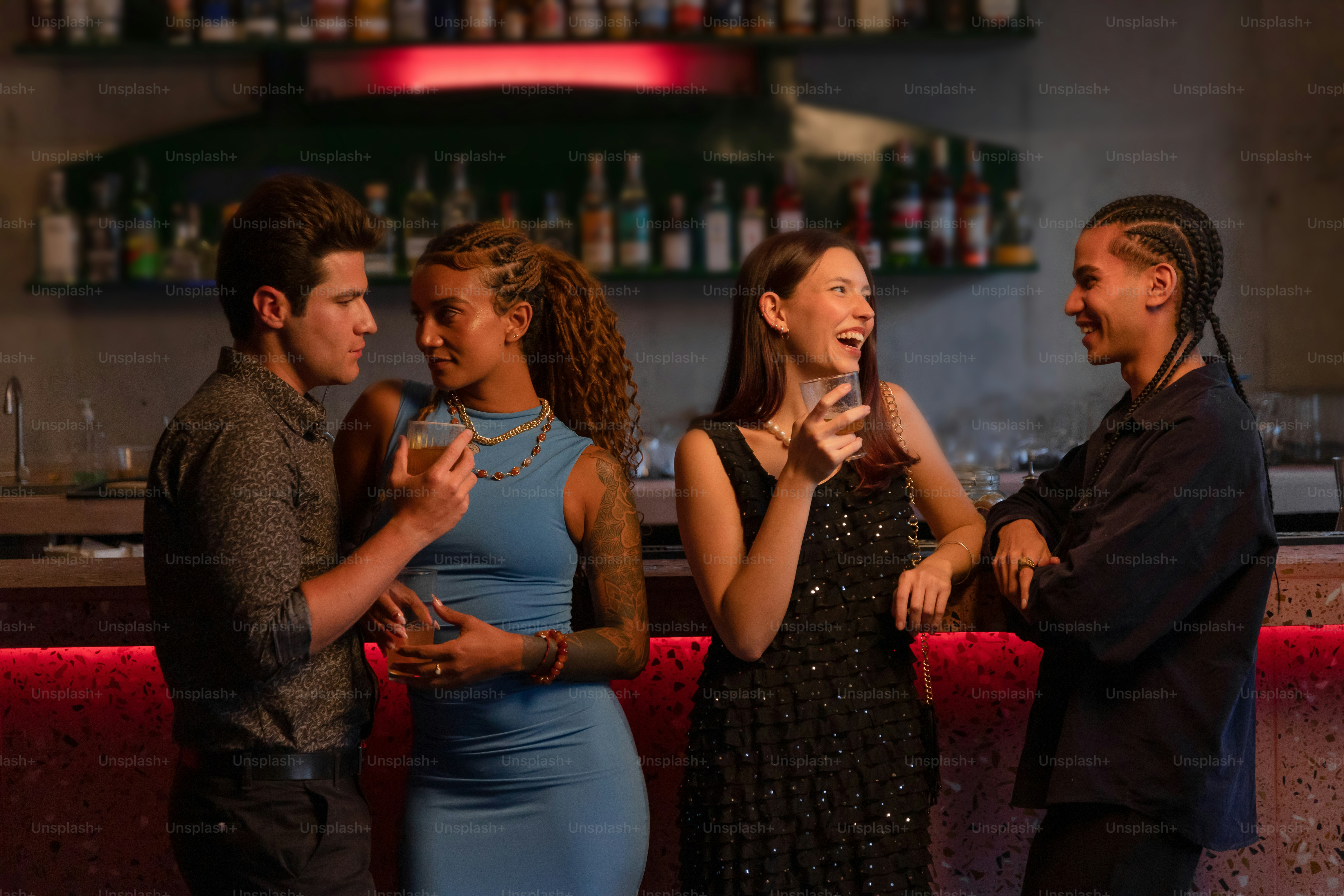 Friends enjoy drinks and conversation at a bar. photo – Couple Image on  Unsplash