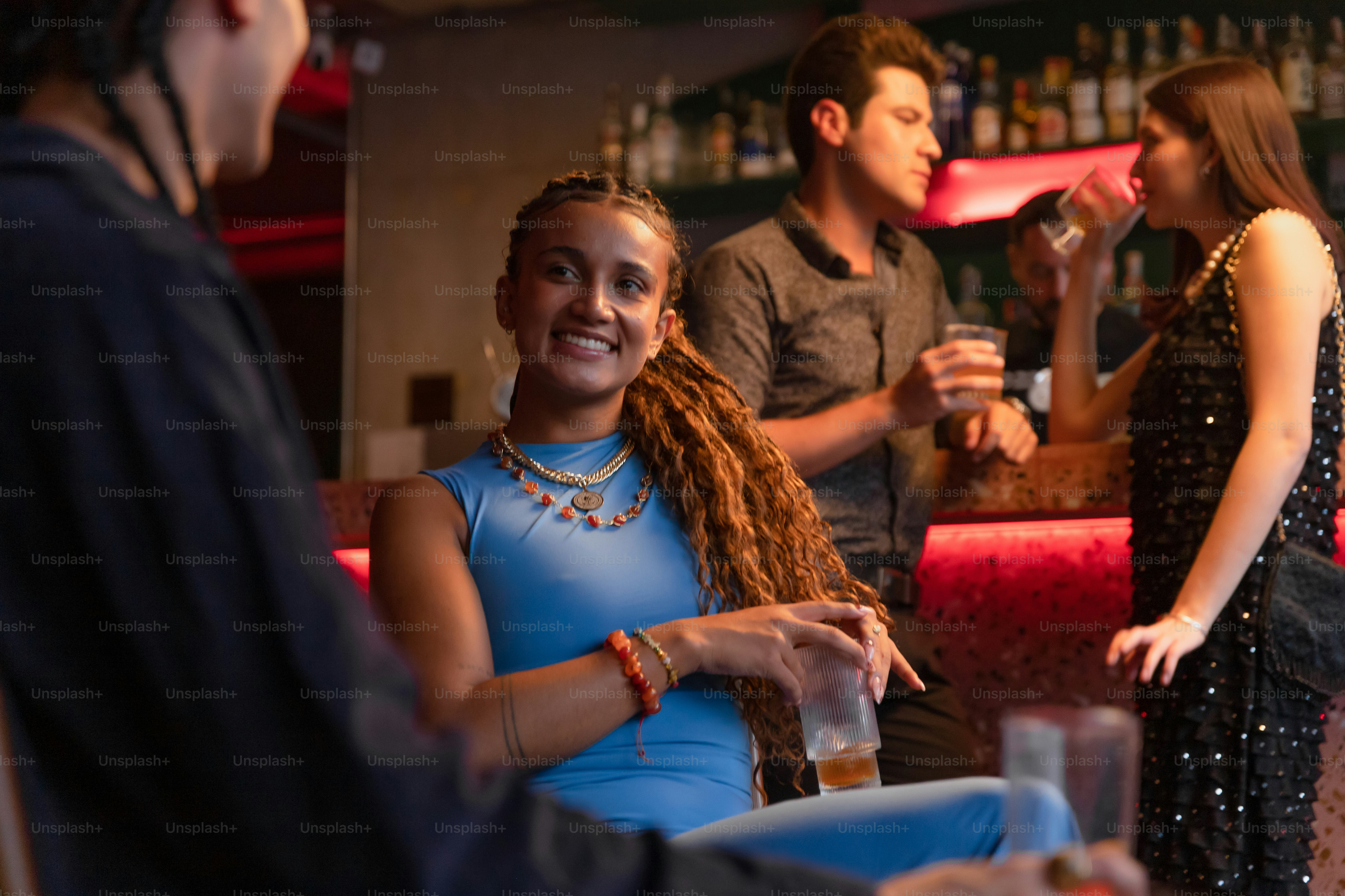 People are laughing and enjoying themselves at a bar.