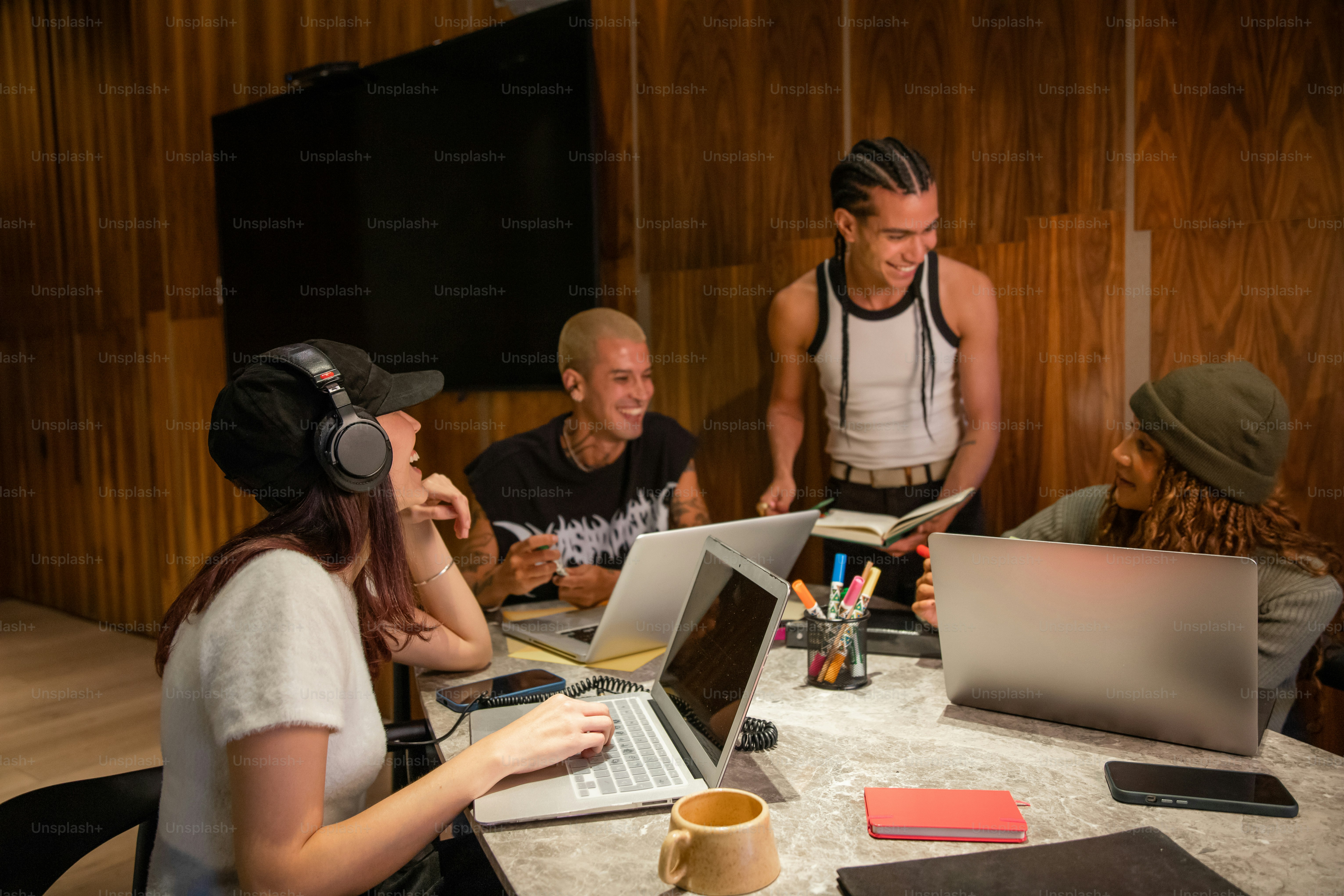Young people work and laugh together at a table