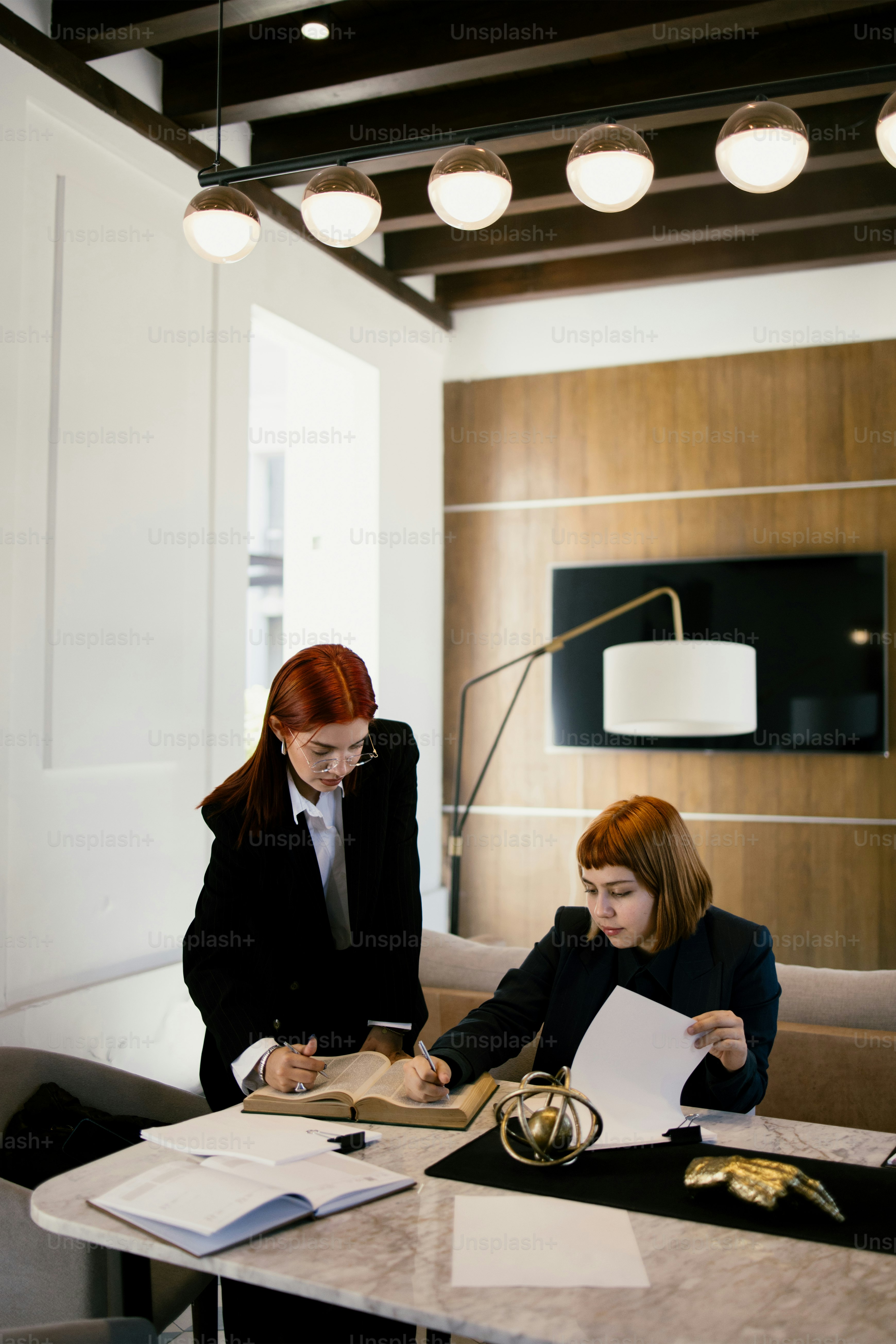 Two people are working together at a table.