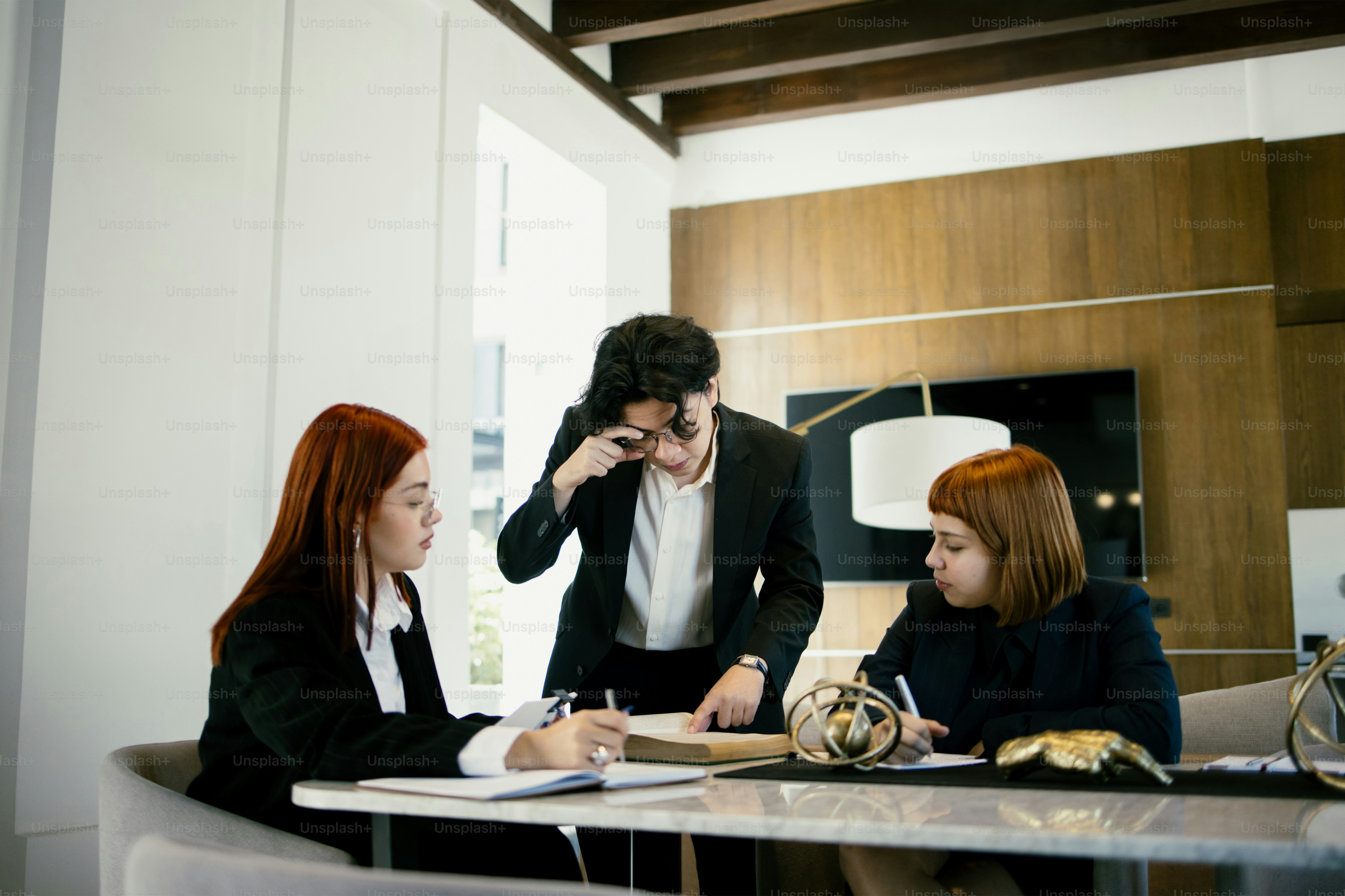 Three businesspeople are in a meeting.