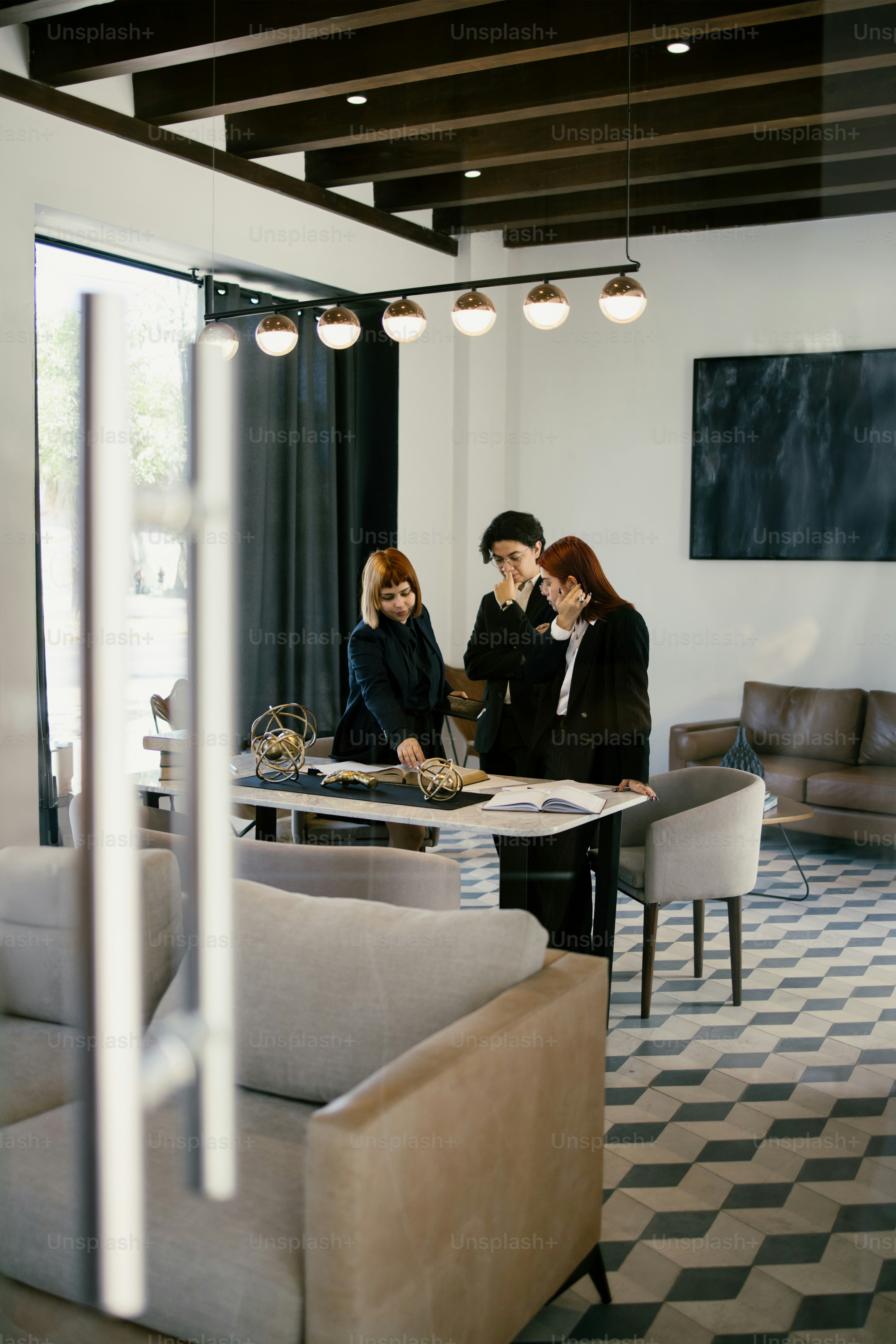 Three people collaborating in a bright, modern office.