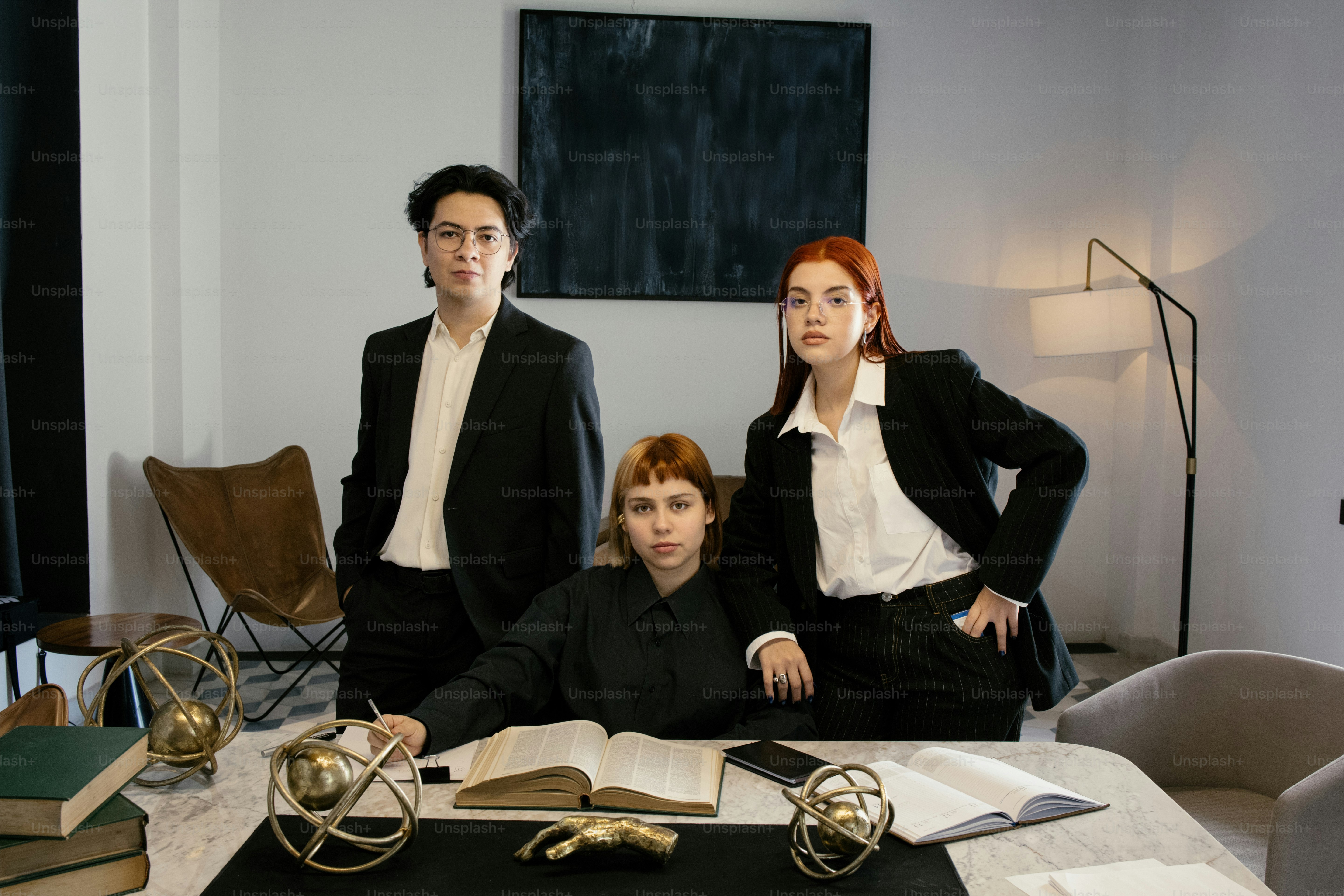 Three professionals pose together for a portrait.