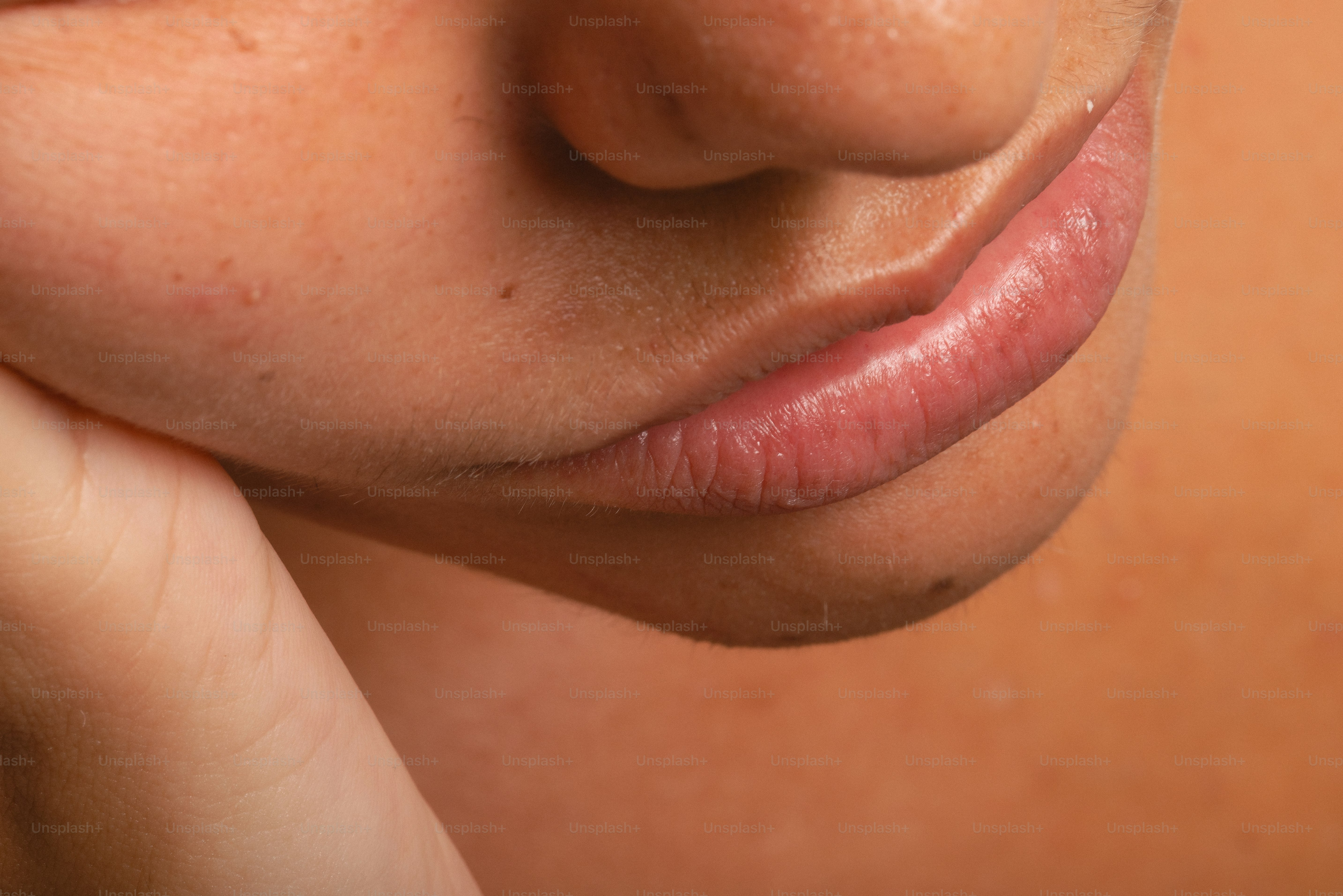 Close-up of a person's lips and chin.