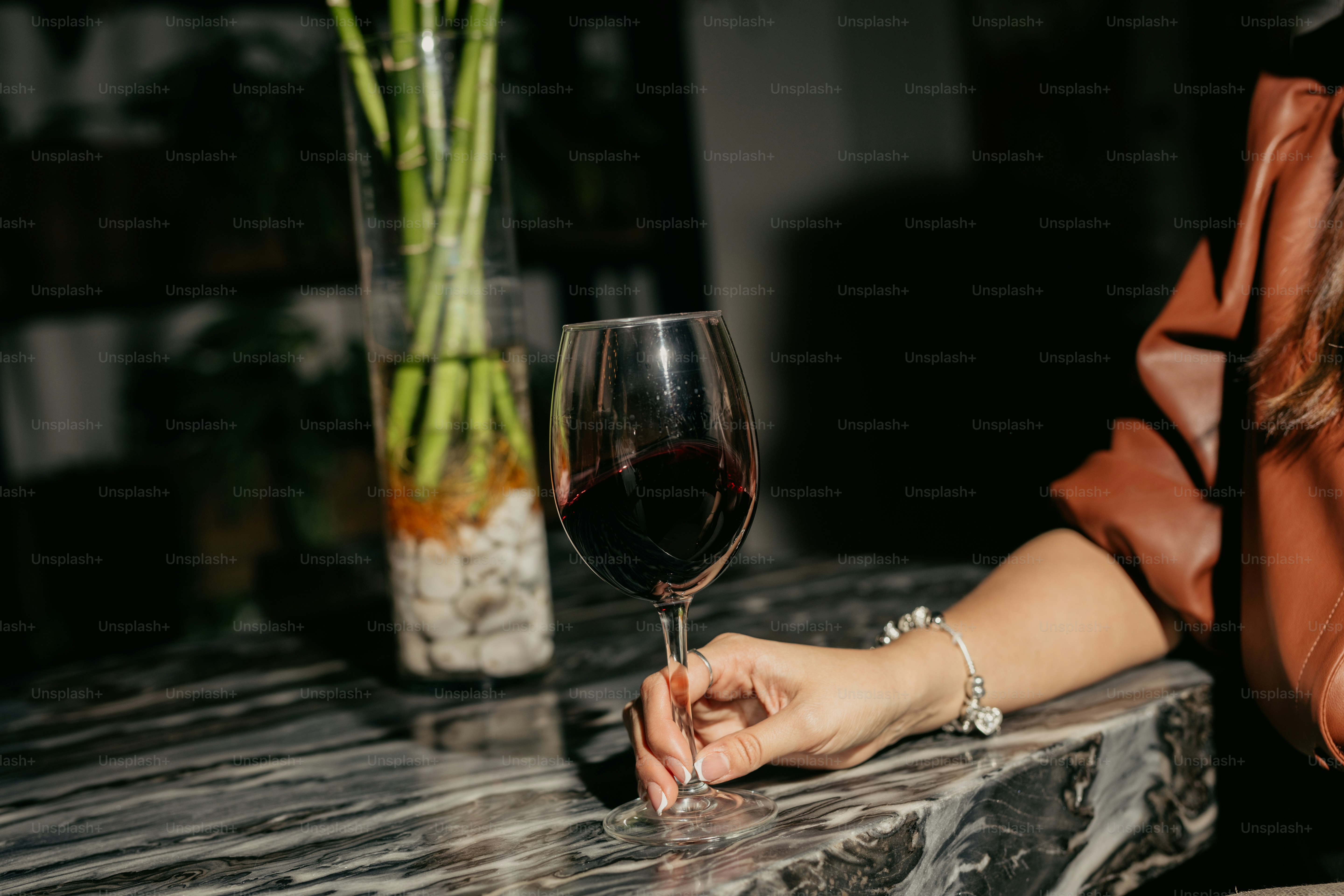 A woman holding a glass of wine in her hand photo  Free Party Image on  Unsplash