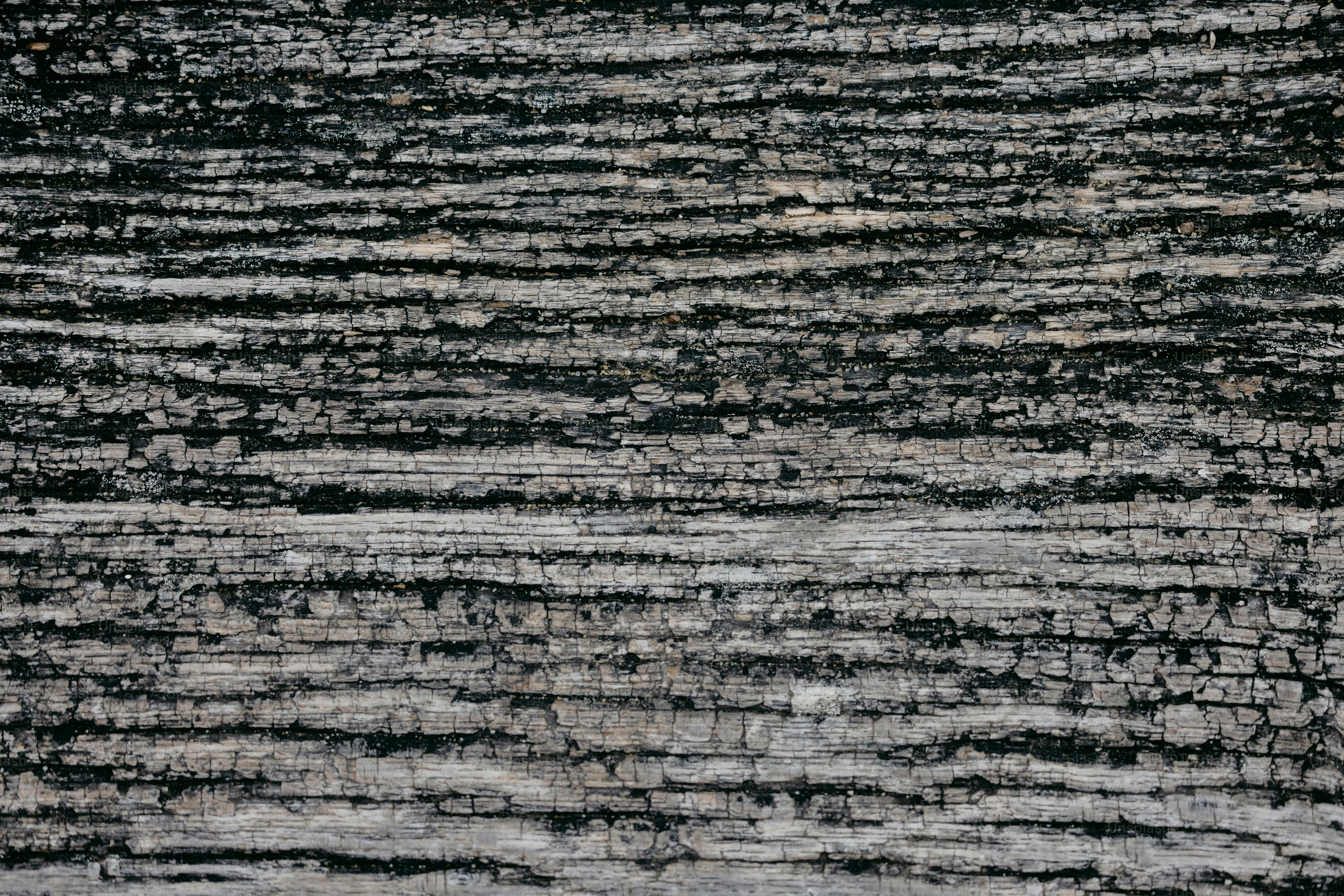 Textured, gray surface with horizontal lines.