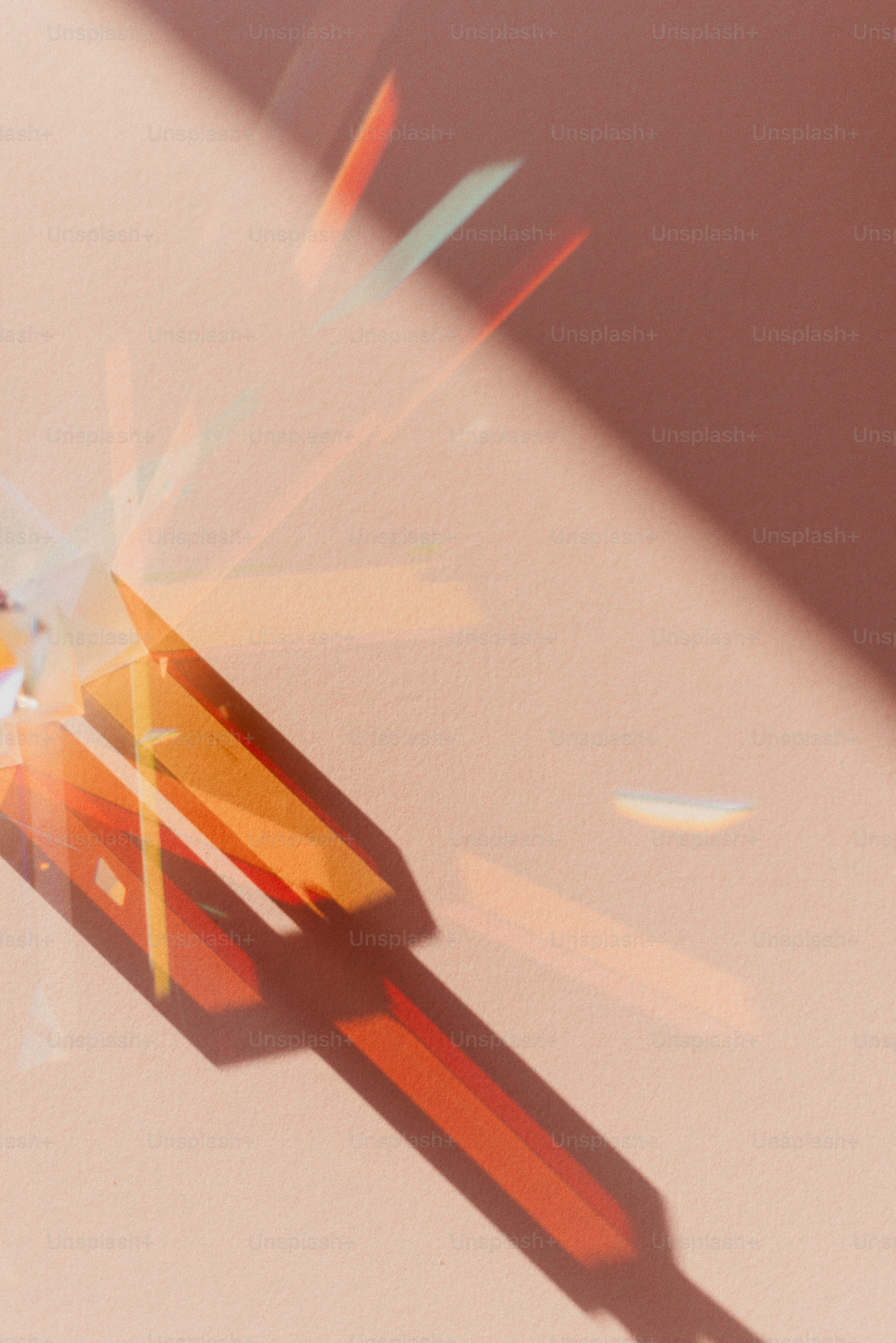 Light refracting through a prism creates colorful shadows.