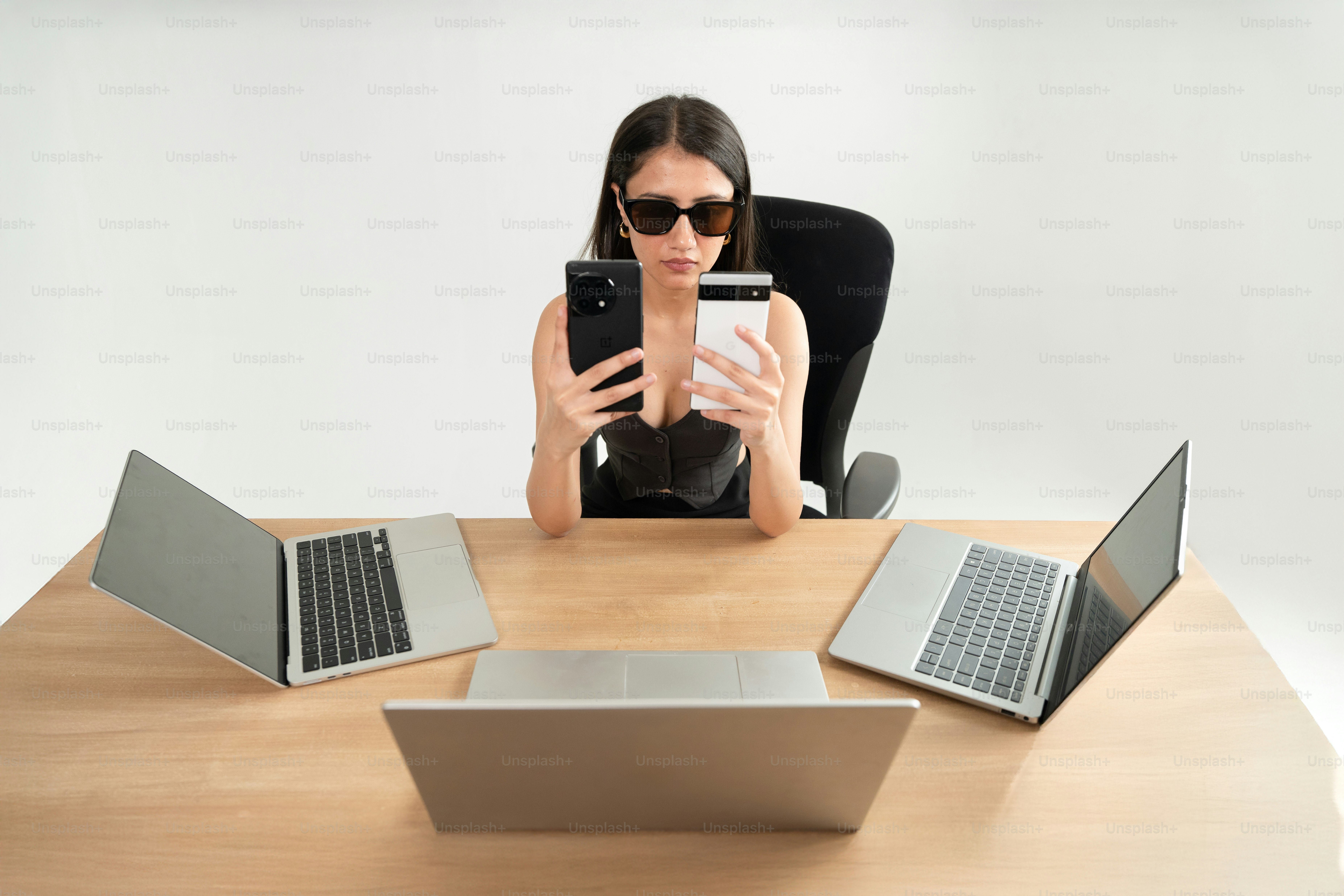 A man poses with several laptops. photo – Technology Image on Unsplash