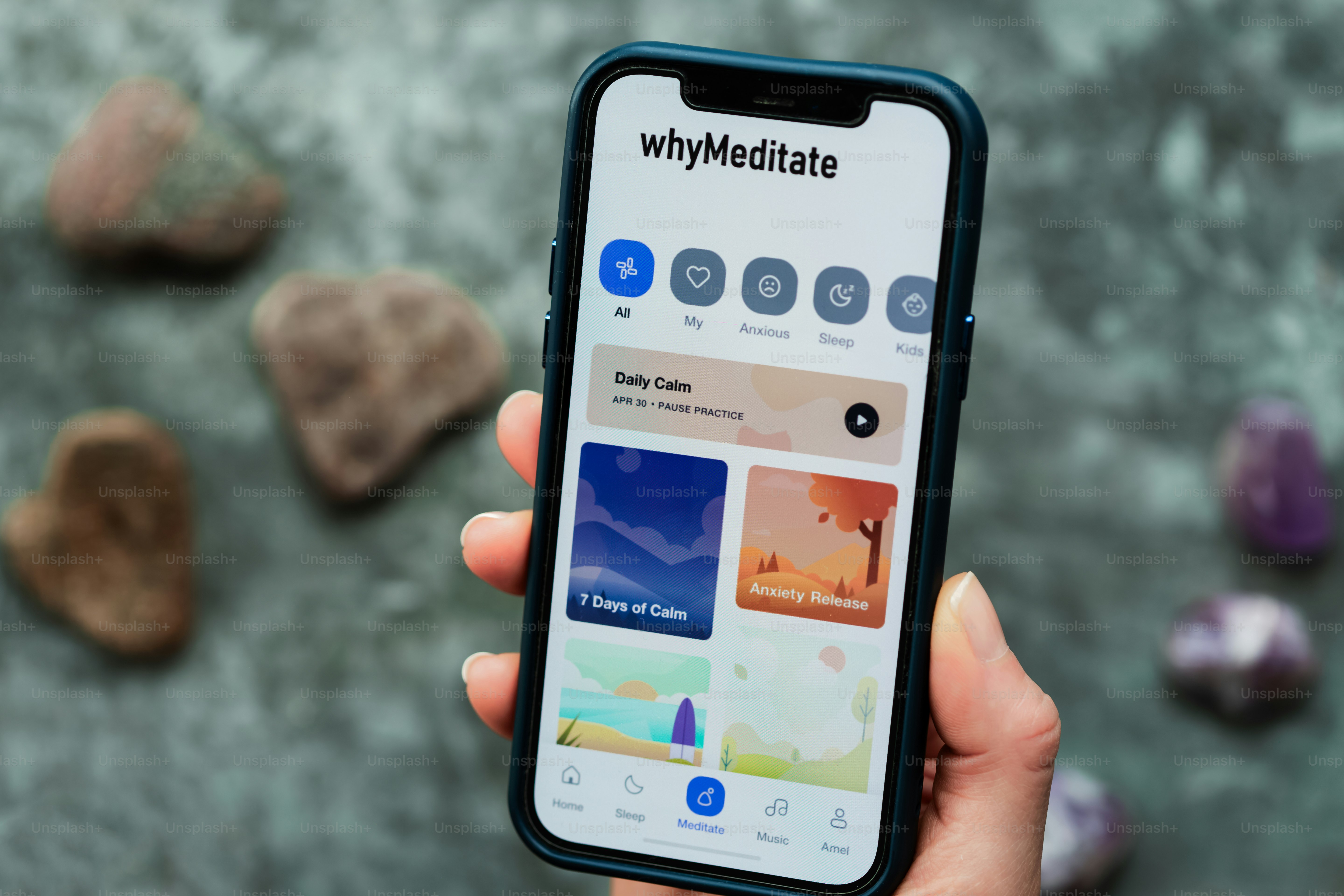 A person using a "whymeditate" app on their phone.