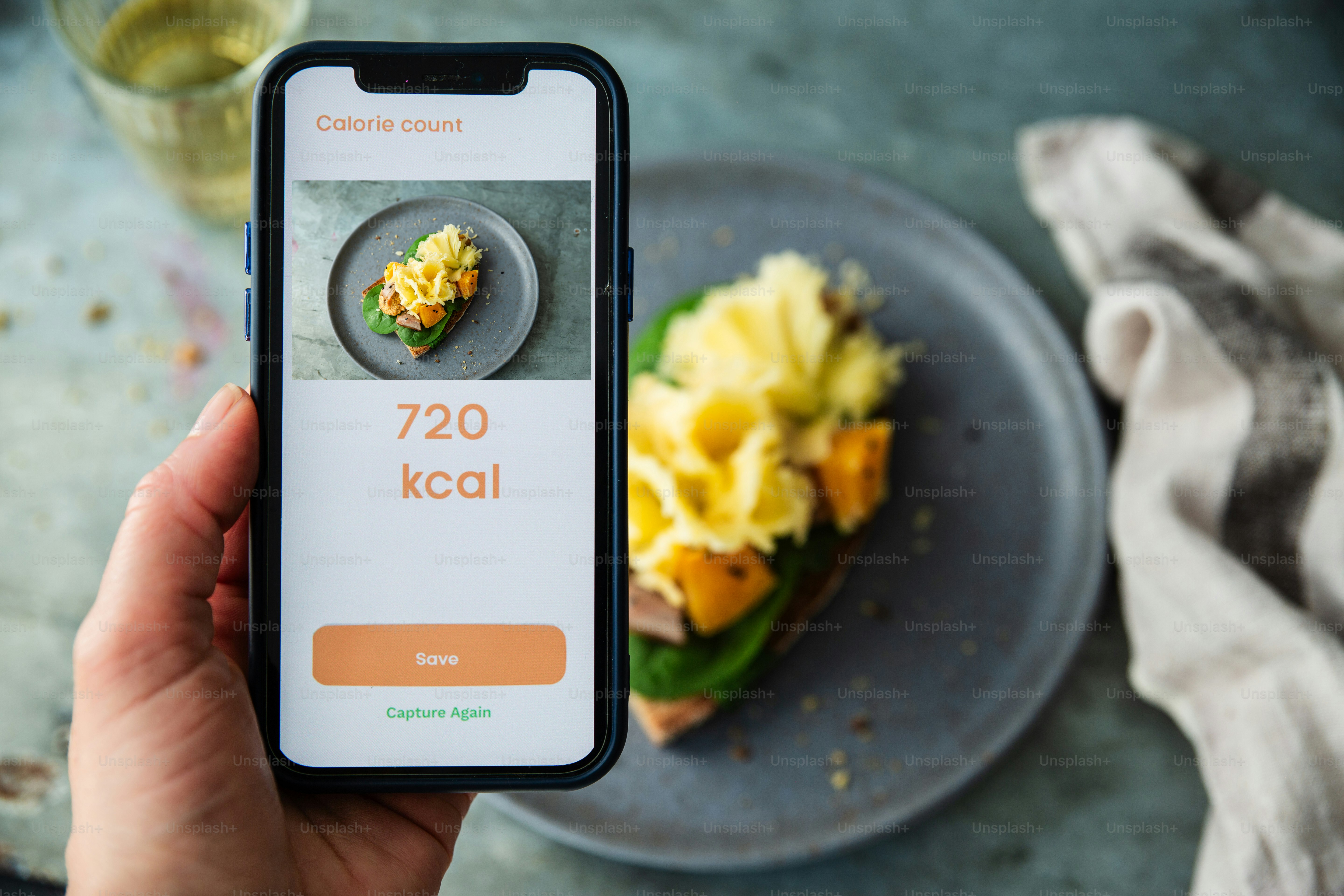 Phone screen shows the calorie count of food.
