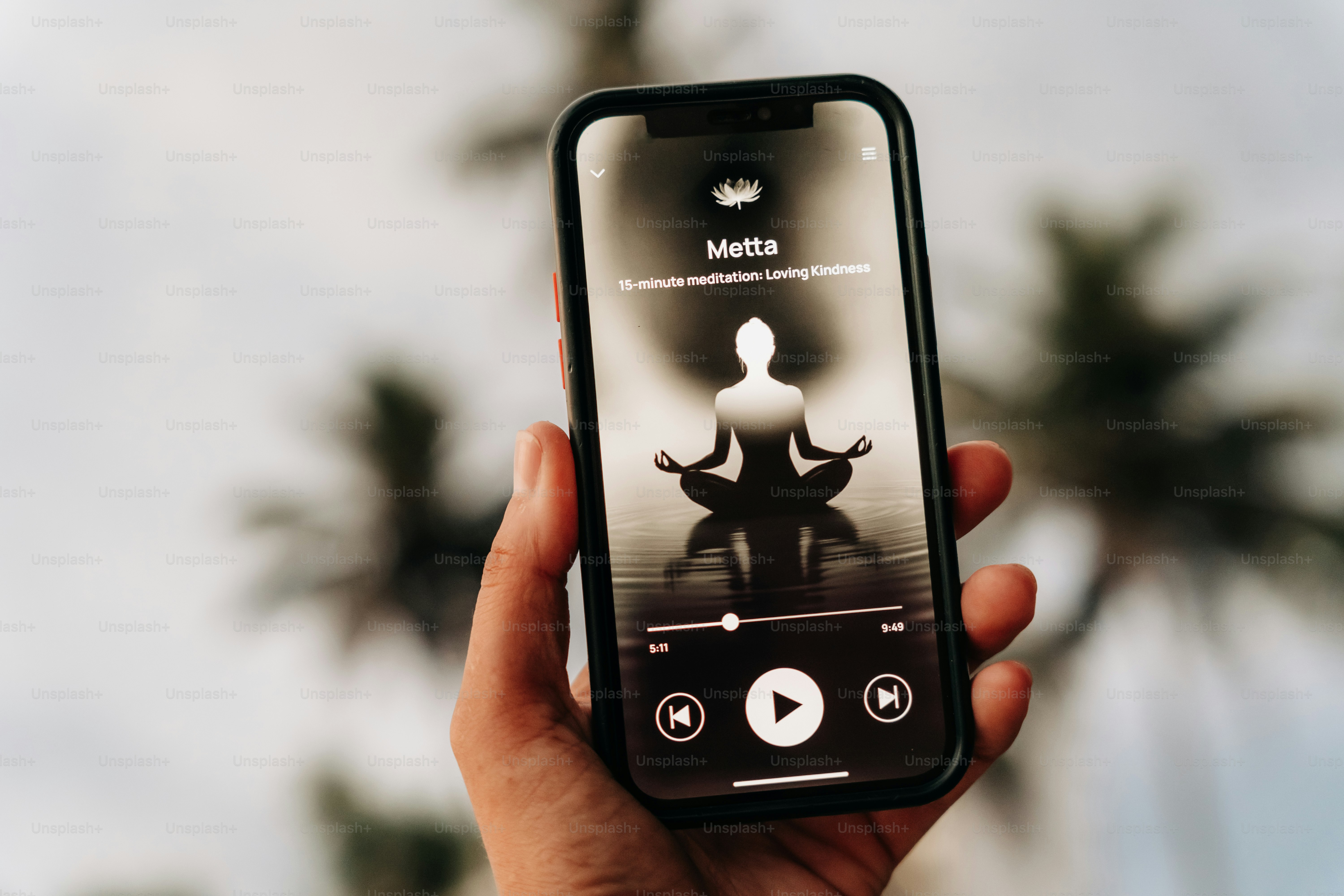Listening to a meditation session on a phone.