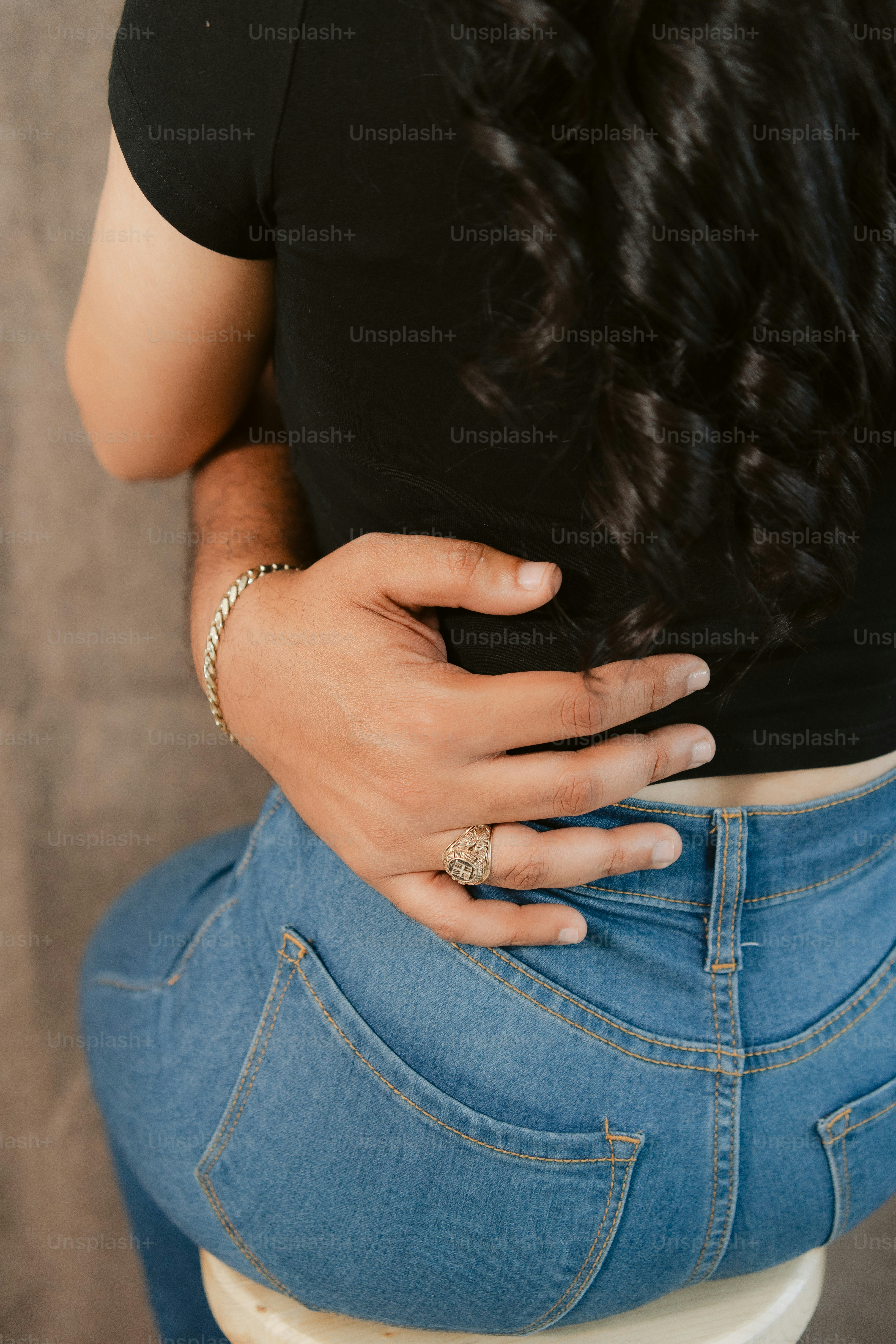 A person is embraced from behind.