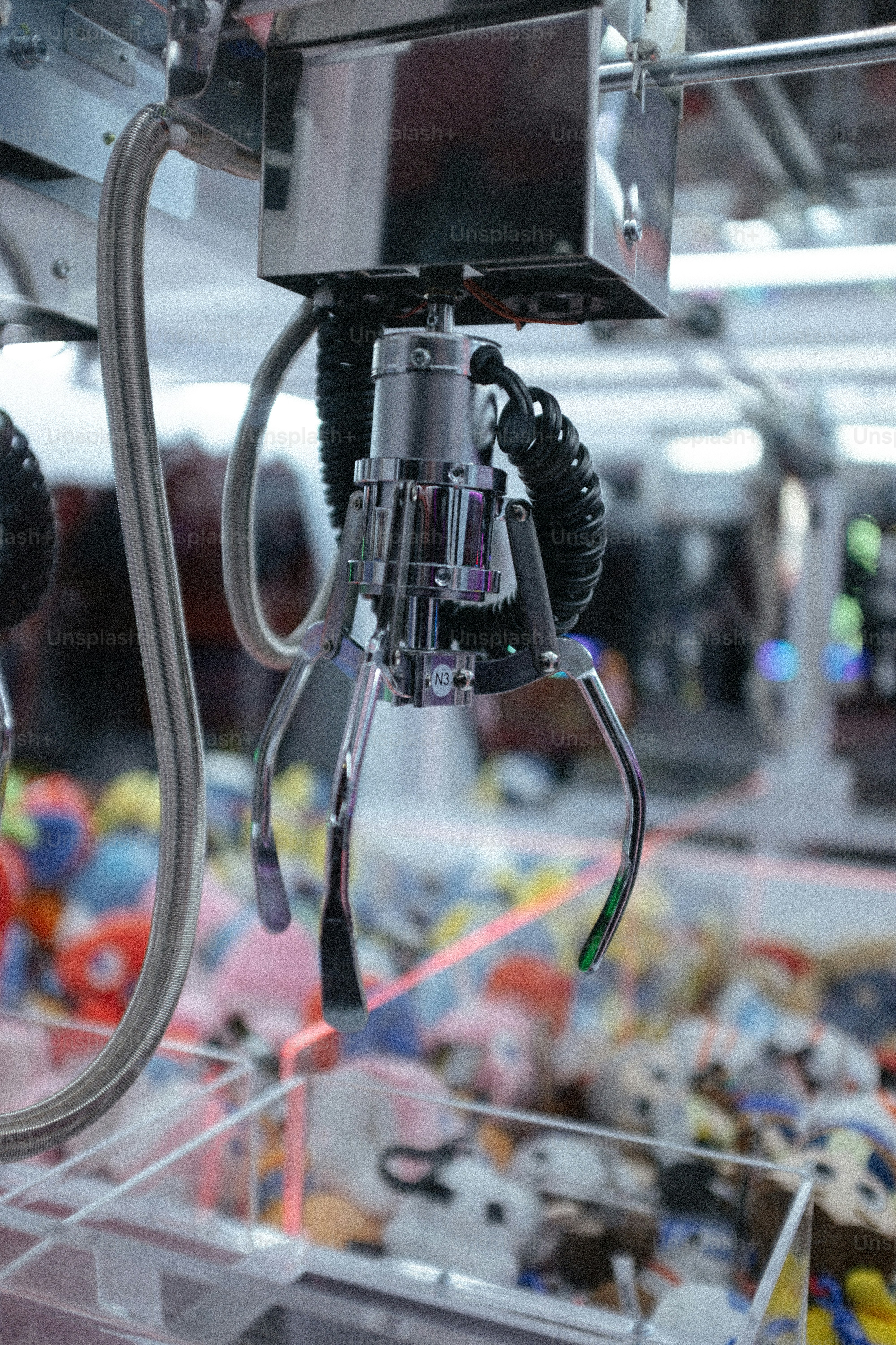 The claw machine prepares to grab a prize.