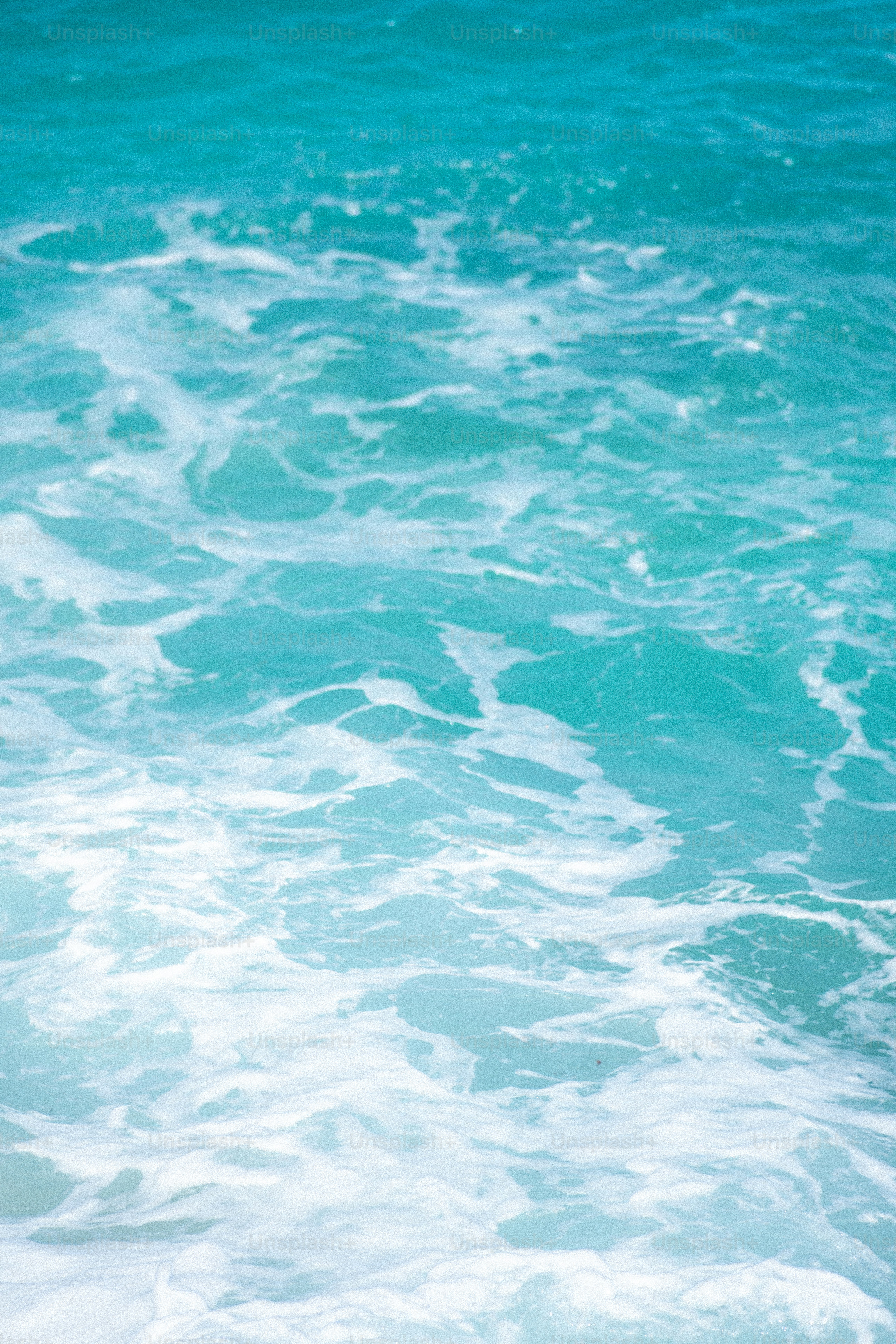 Turquoise water with white foamy waves.