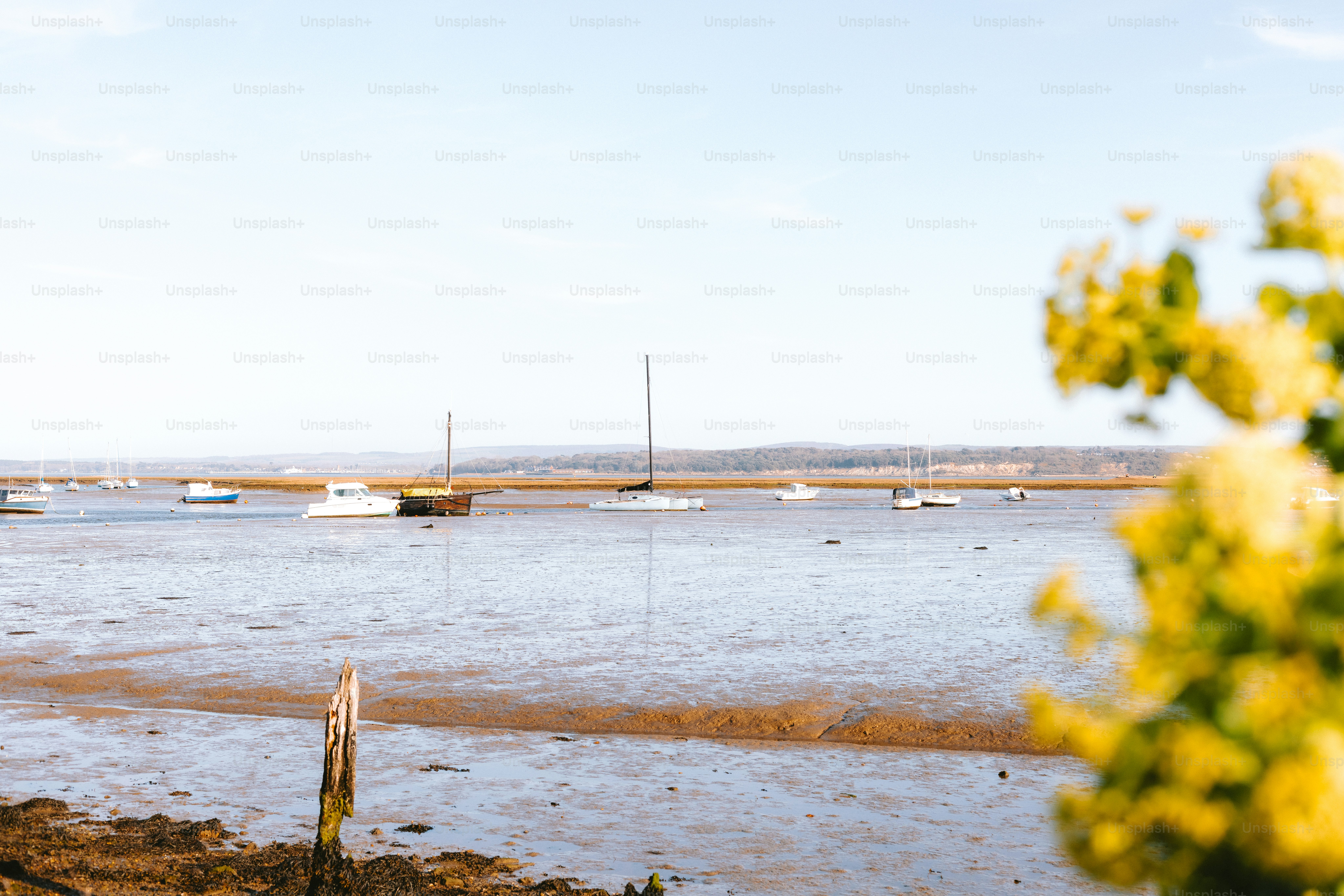 Boats are anchored in the calm, blue water.