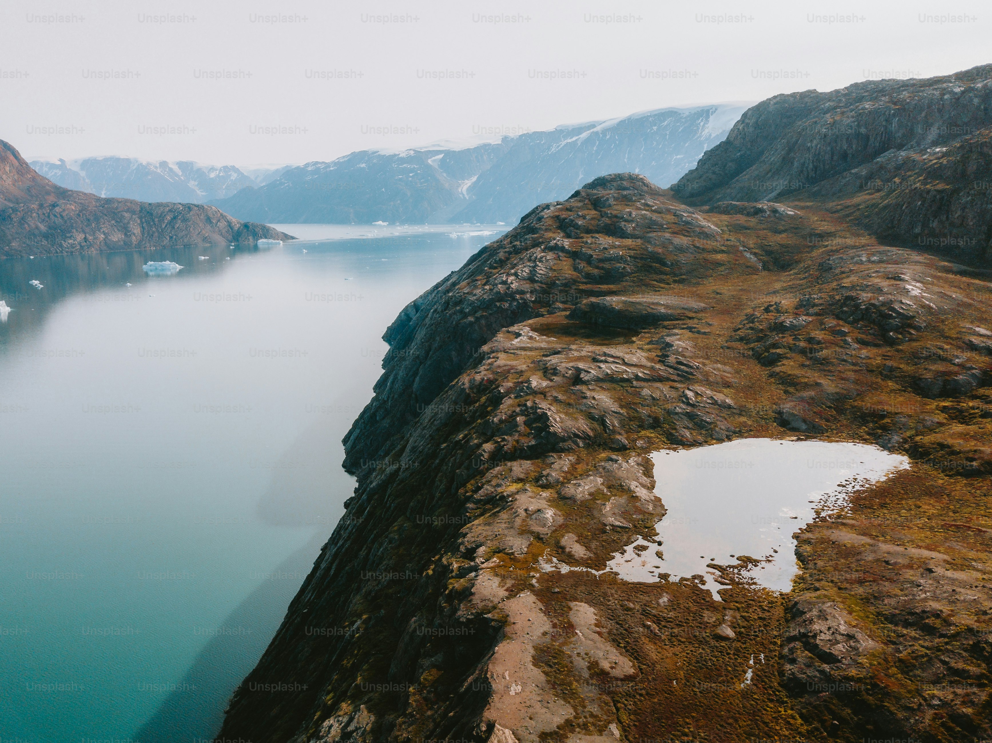 Mountains overlook a tranquil lake in a scenic landscape.