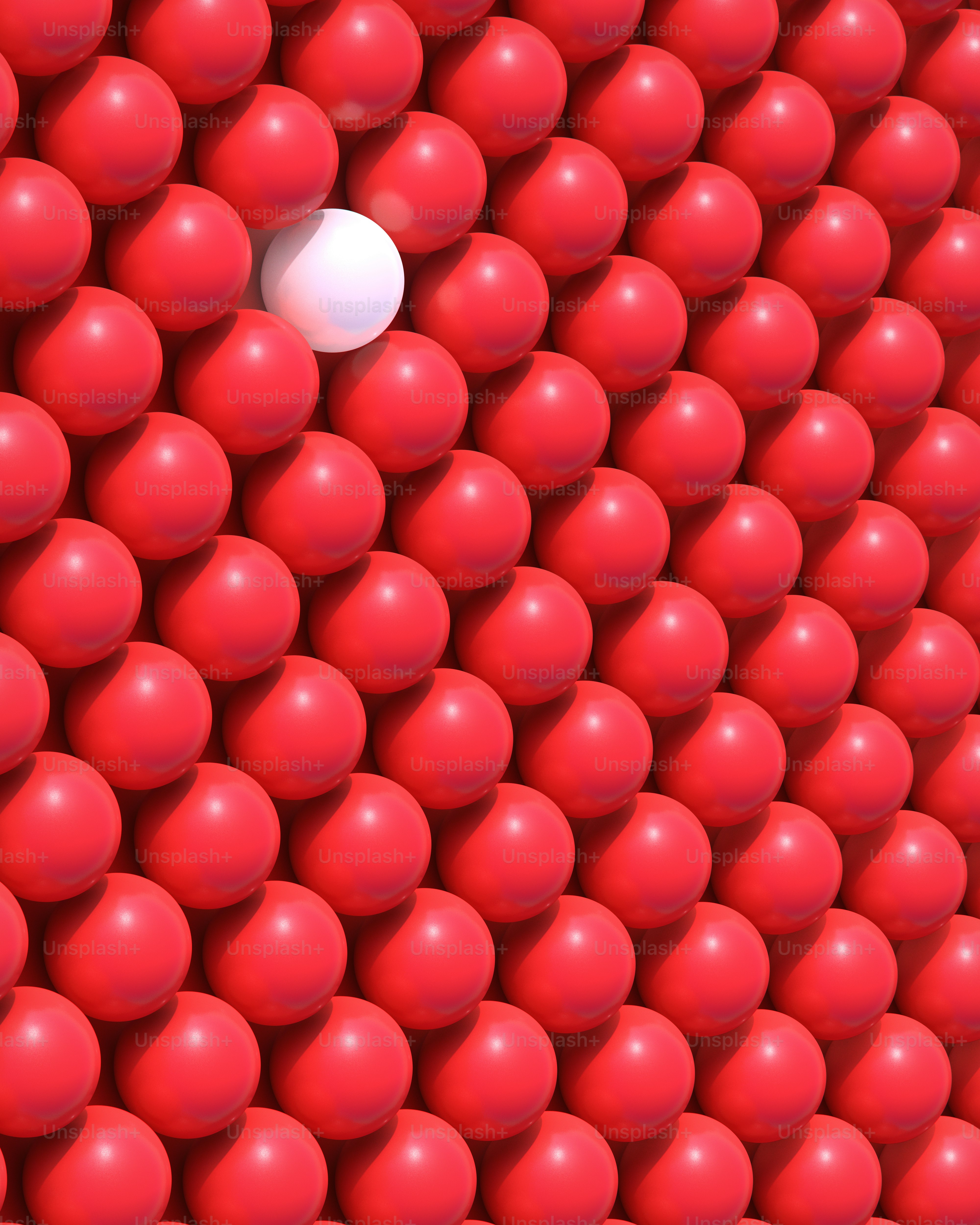 Une sphère blanche se détache parmi les rouges.