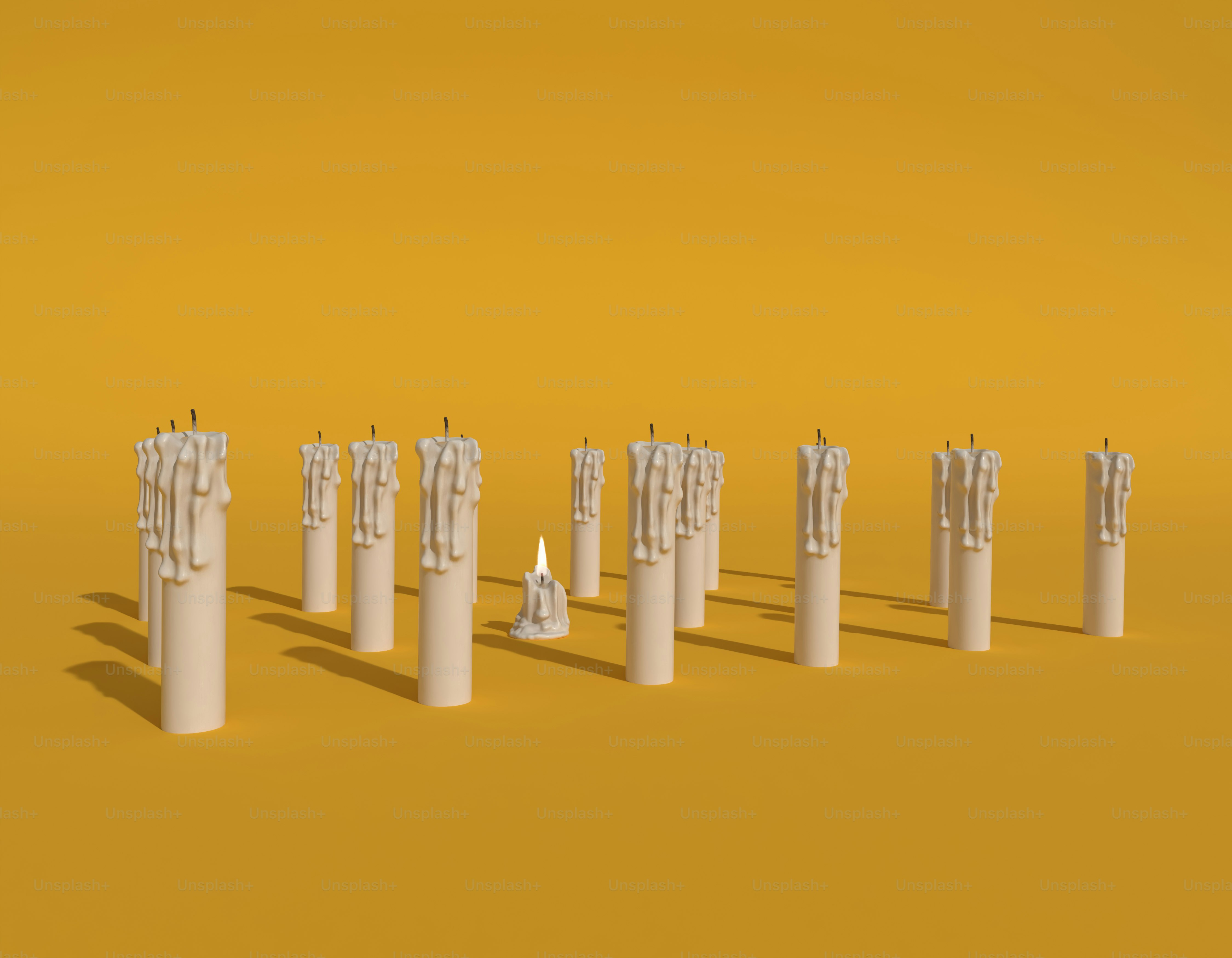 A group of candles on a yellow surface.