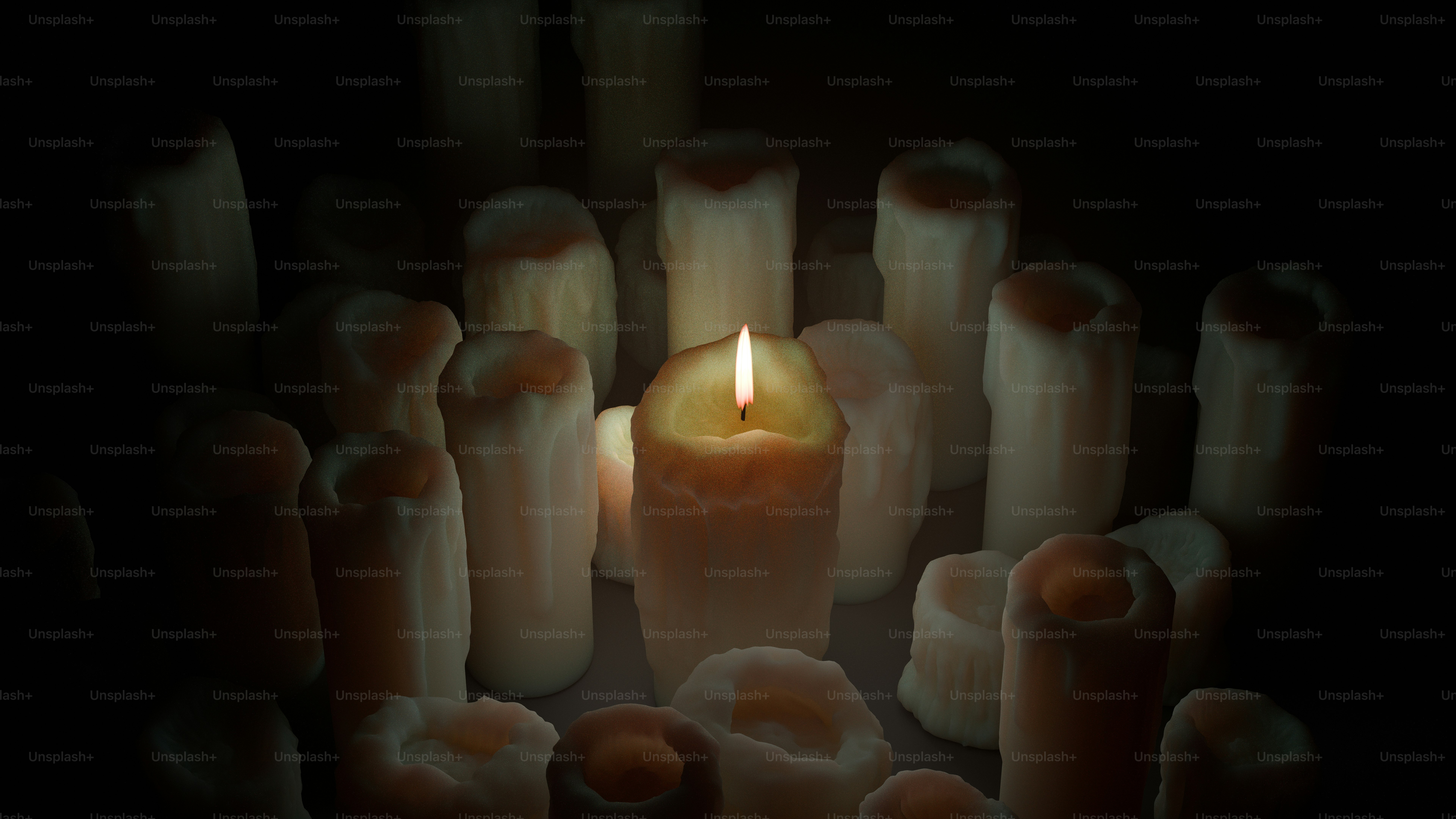 One lighted candle shines amidst many dark ones.