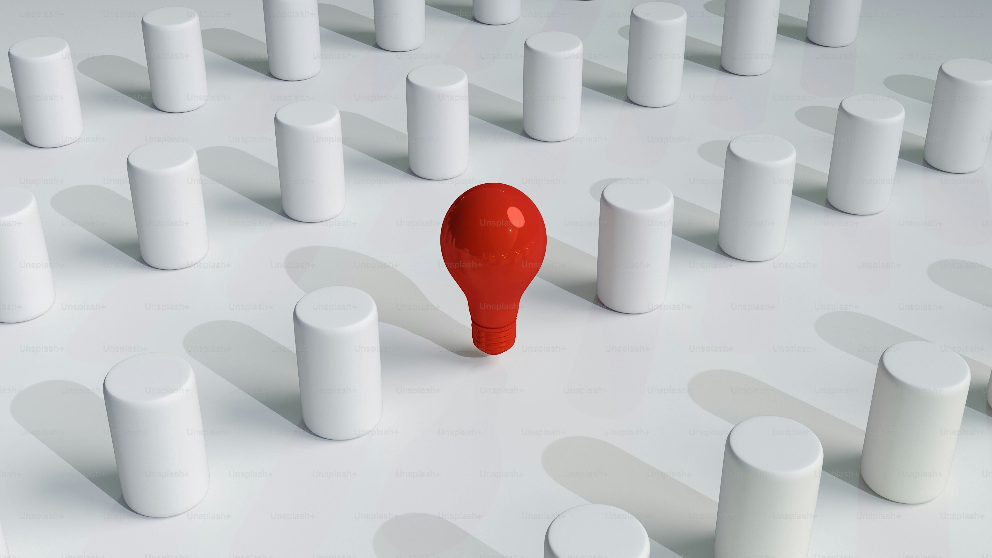 A unique red object stands out from white cylinders.