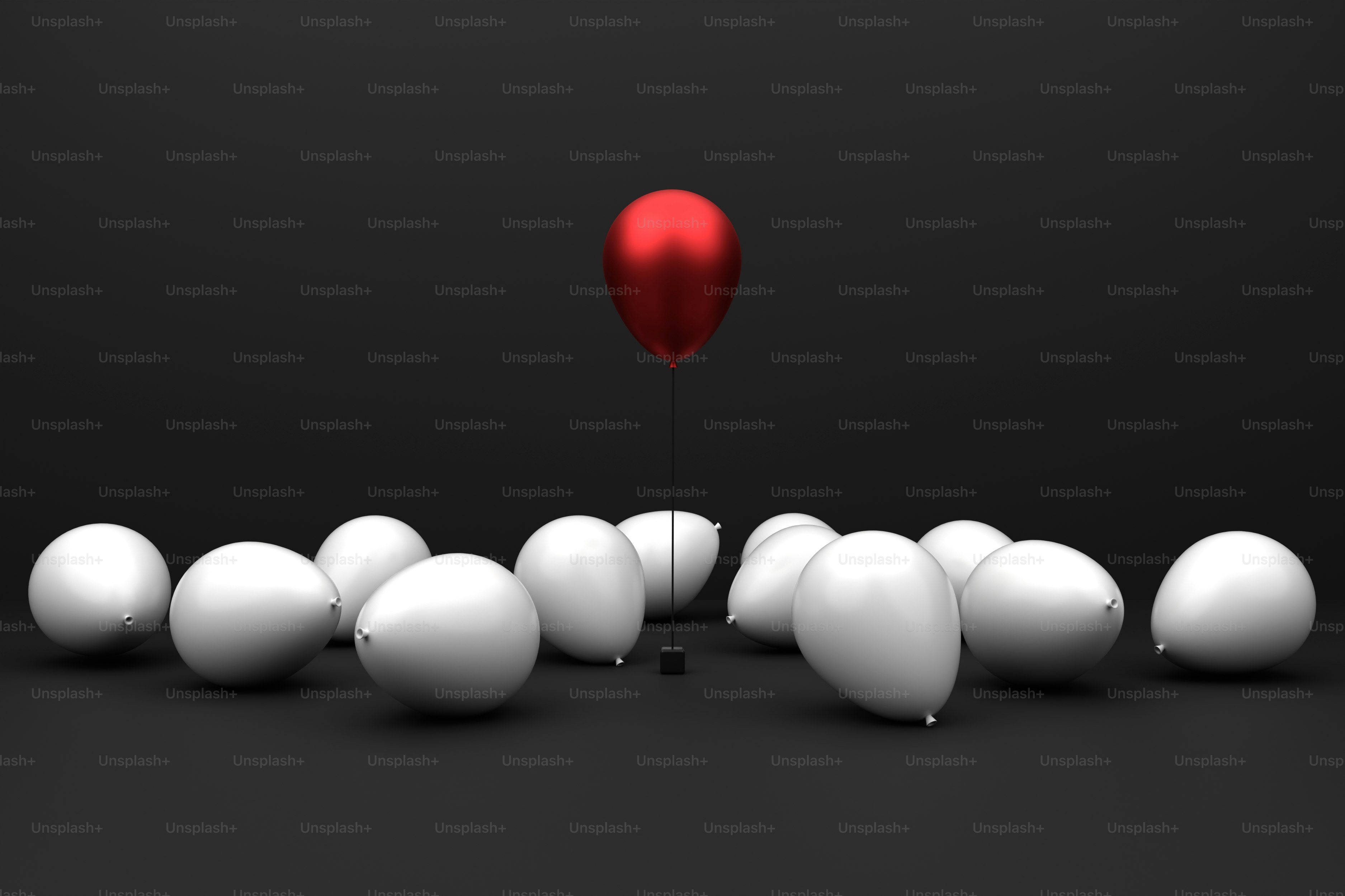 A red balloon floats above white ones.