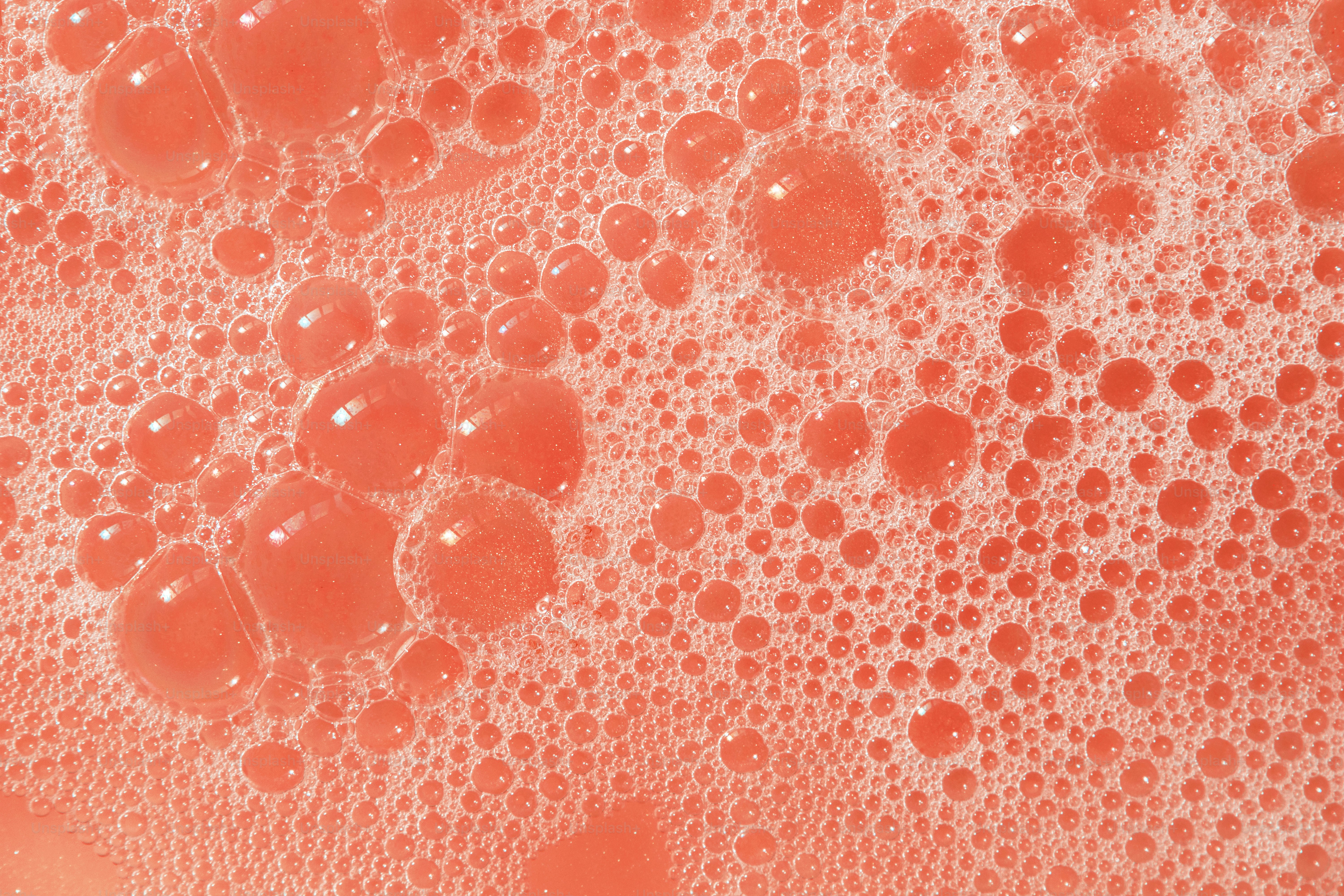 Reddish bubbles and foam fill the picture.