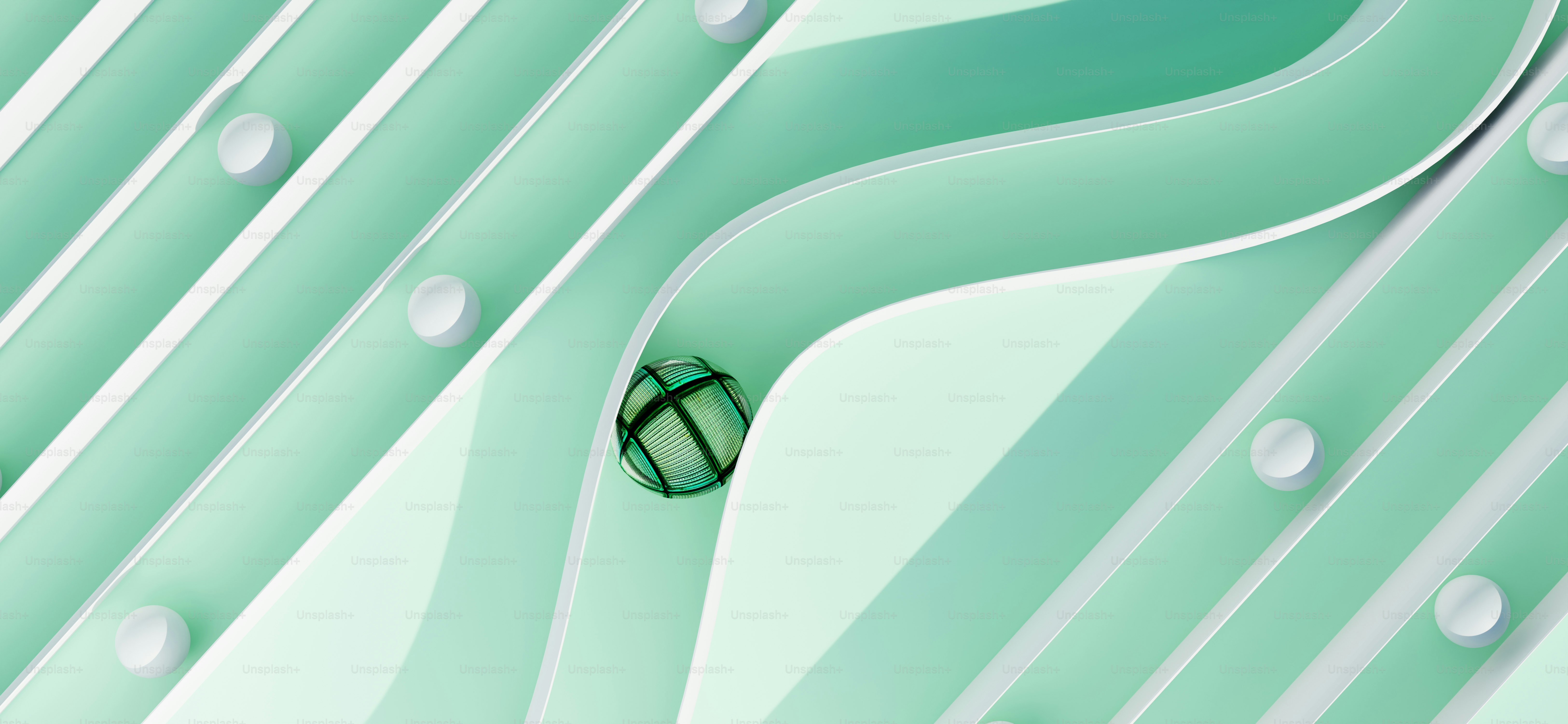 A ball rolls along a curved, light green track.
